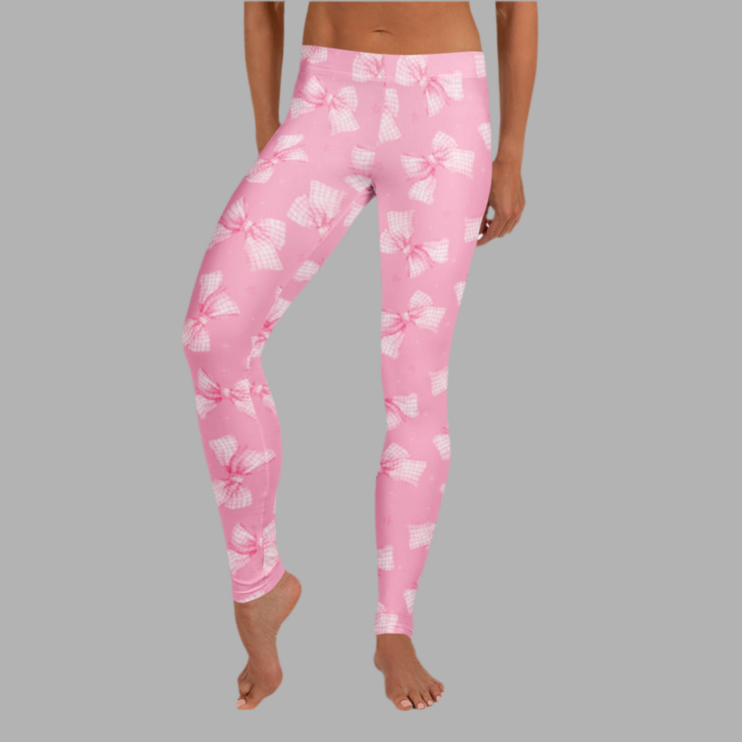 Image: Stylish pink bow leggings for women styled with a white tee and sneakers, showing off a cute and feminine outfit. This bow print is part of our matching collection for moms and daughters who love twinning fashion moments. Soft and flattering for every shape, by jaecrece.