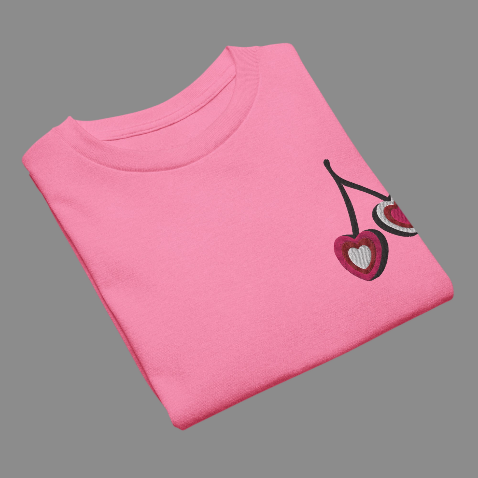 Image: Cherry Embroidery Shirt for Girls. This Valentines Day crewneck tee features two embroidered cherries on the left chest in red, pink and white with black stems. Great gift for tweens and toddlers who love the cherrycore aesthetic, by jaecrece