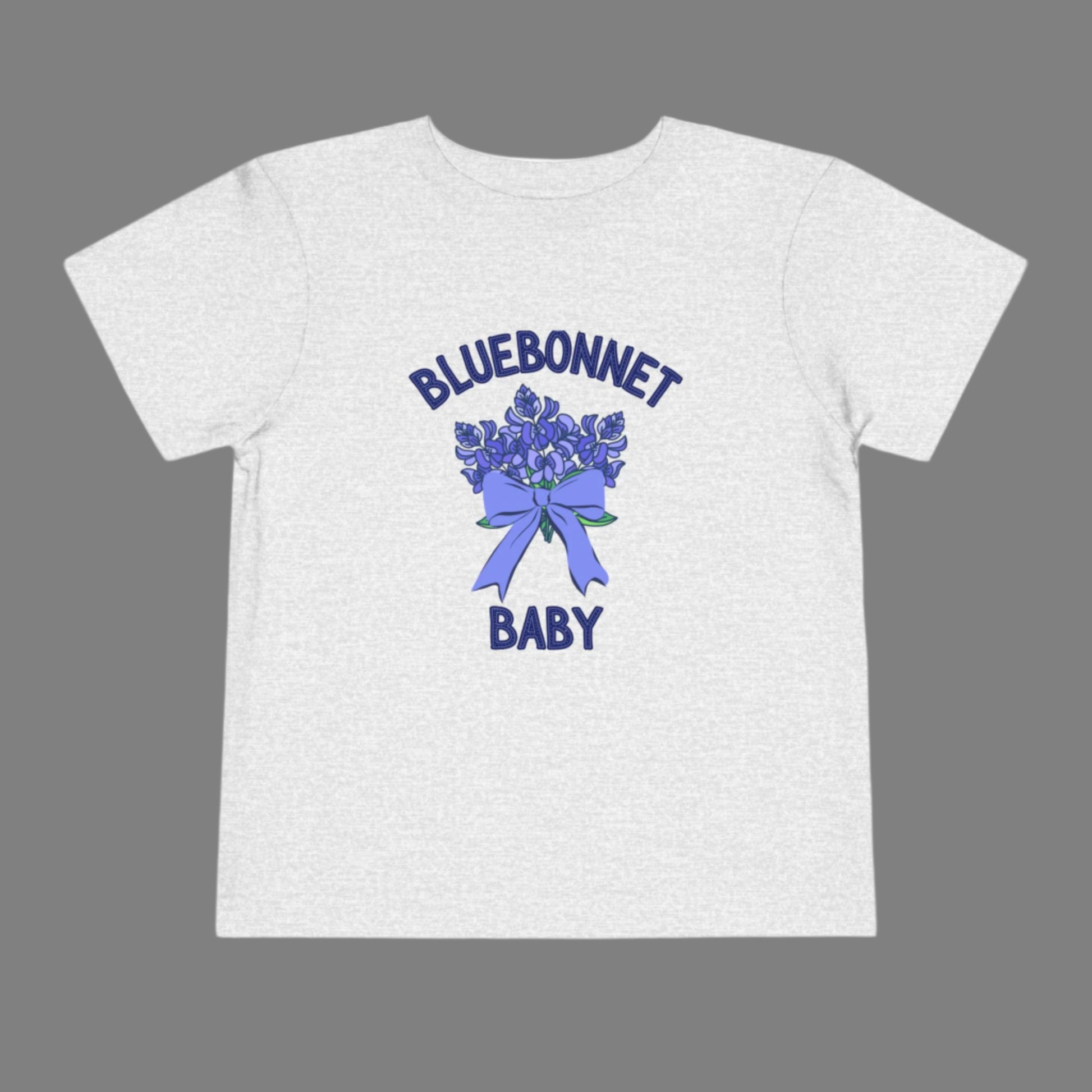 Image: A soft, breathable toddler t-shirt featuring a lovely bluebonnet print, celebrating the Texas state flower. Perfect for spring outings, this tee is ideal for bluebonnet field photos, playdates, or family picnics. A charming gift for baby showers or birthdays, it allows little Texans to embrace their roots. Its lightweight fabric ensures comfort while showcasing a nature-inspired design that makes any outfit extra special, by jaecrece.