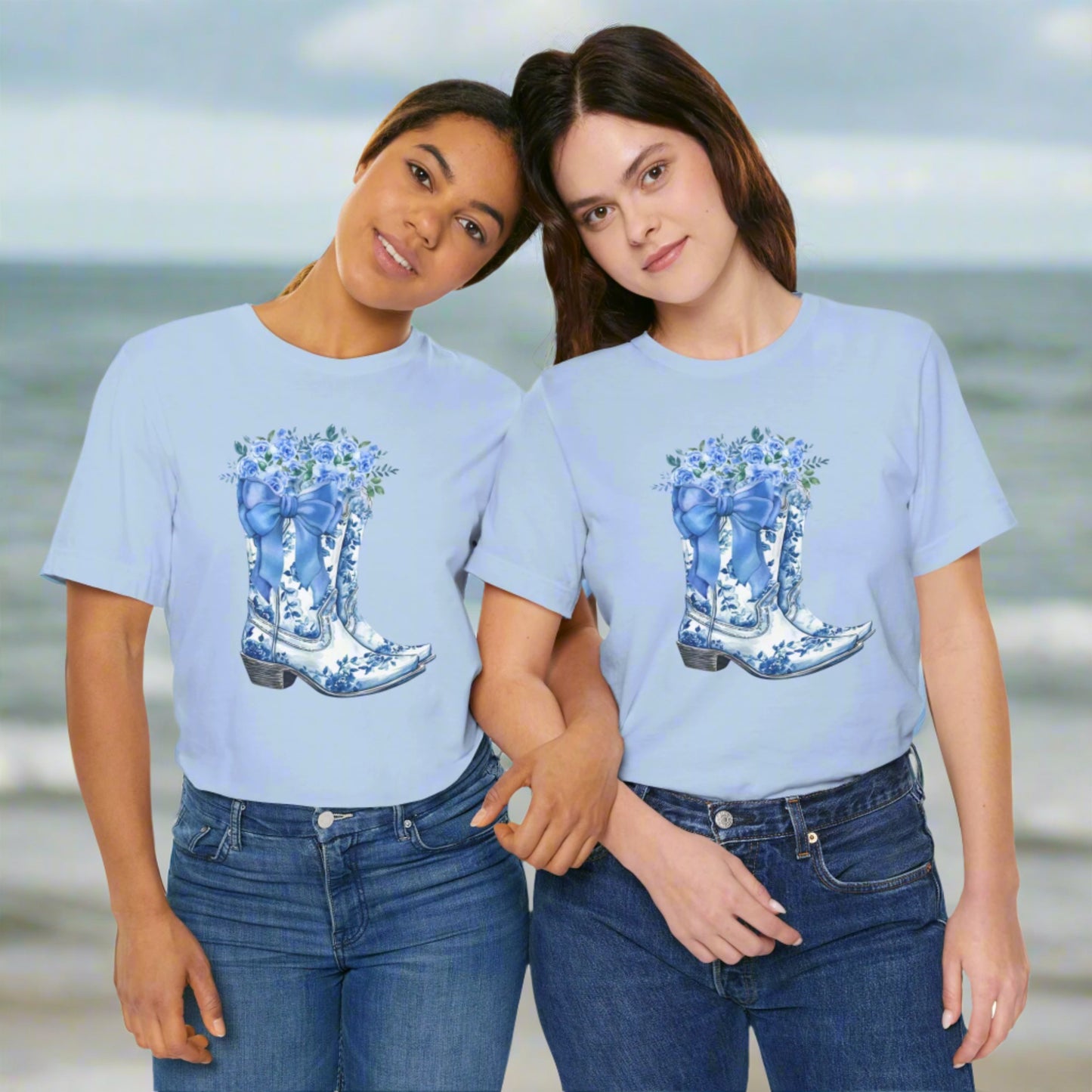 Image: Blue Toile Boots and Bows shirt in sizes for women. This pullover shirt features a pair of coastal cowgirl aesthetic cowboy boots with a blue bow and blue wildflowers. This country themed sweater makes a perfect gift for your daughter, or for the boujee mama in your life, by jaecrece
