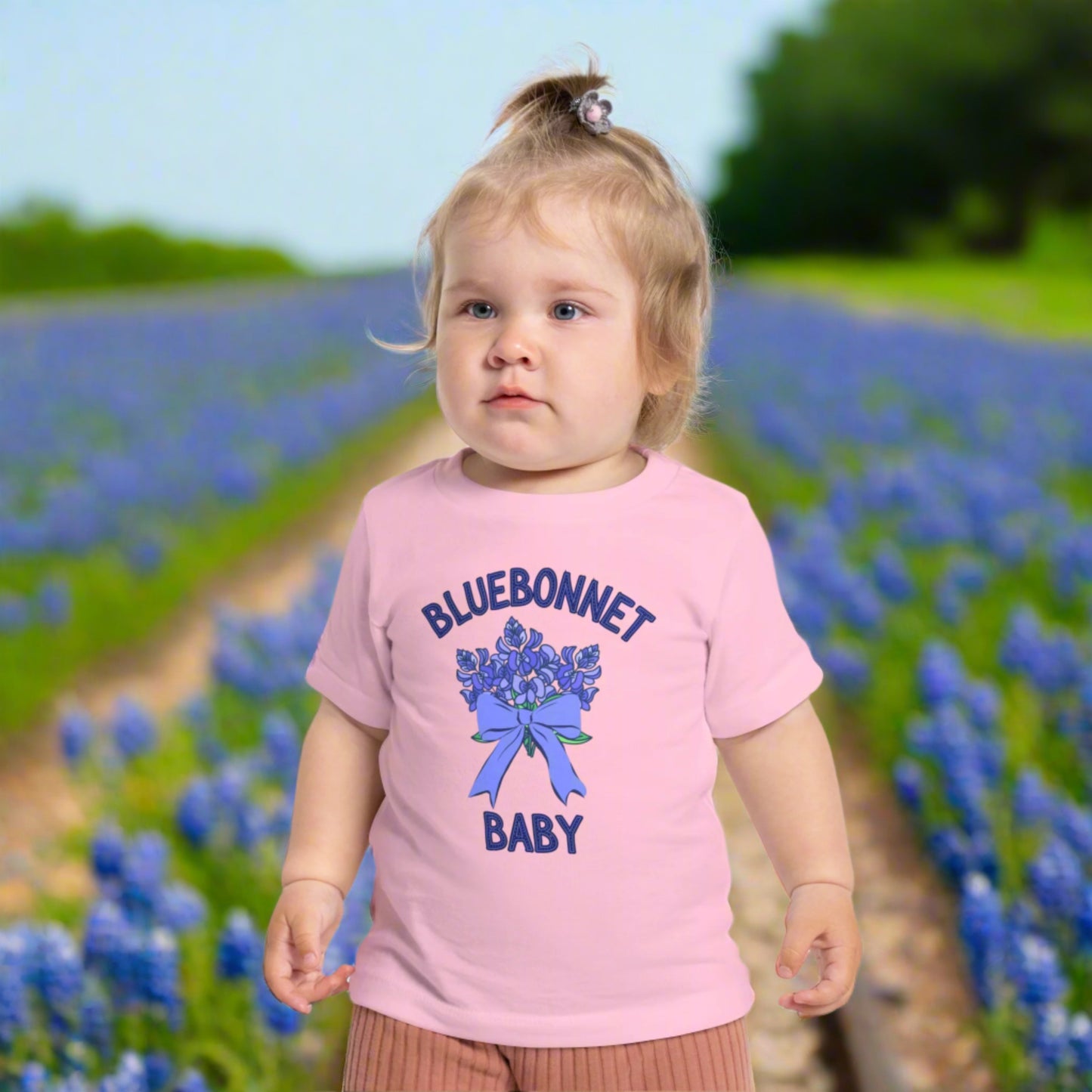 Image: A soft, breathable toddler t-shirt featuring a lovely bluebonnet print, celebrating the Texas state flower. Perfect for spring outings, this tee is ideal for bluebonnet field photos, playdates, or family picnics. A charming gift for baby showers or birthdays, it allows little Texans to embrace their roots. Its lightweight fabric ensures comfort while showcasing a nature-inspired design that makes any outfit extra special, by jaecrece.