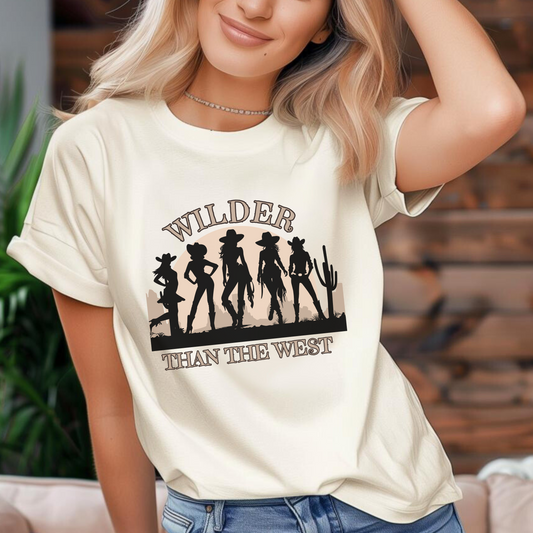 Wilder than the West Shirt in a Natural color with a striking western silhouette design of five cowgirls in the desert with cactus. A stylish Graphic Wear Women tee, it’s available in sizes XS–4XL and also in toddler and girls' sizes for a complete mommy and me match. Whether you’re headed to a music festival rodeo or state Texas coquette event, this country girl shirt delivers a bold quote kids tee look for bachelorette trip styling or southern mama mini bonding.