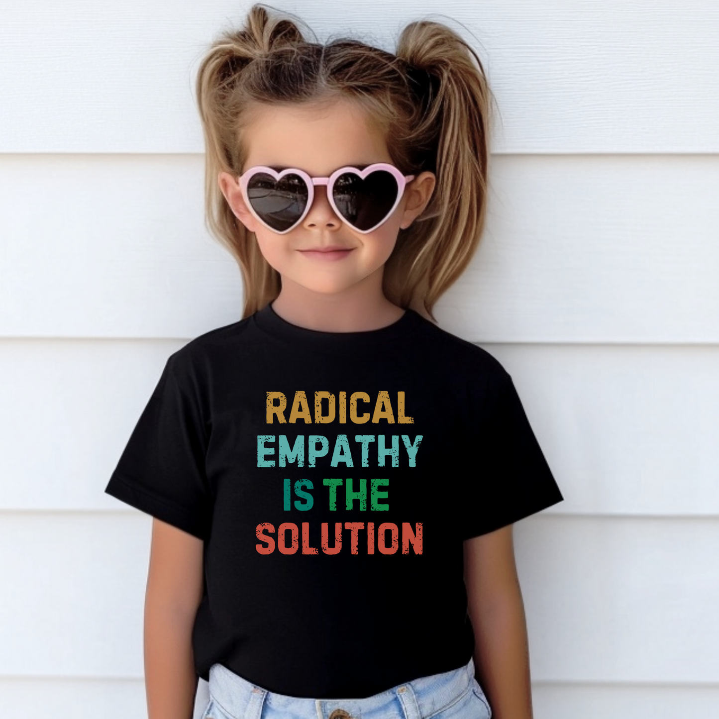 Image: A youth-sized t-shirt with the phrase "Radical Empathy is the Solution" printed boldly across the chest, designed for kids who believe in kindness and inclusion. This activist-inspired shirt makes a great statement piece for young change-makers who want to promote compassion. Perfect for boys and girls who support mental health awareness and social justice, by jaecrece.
