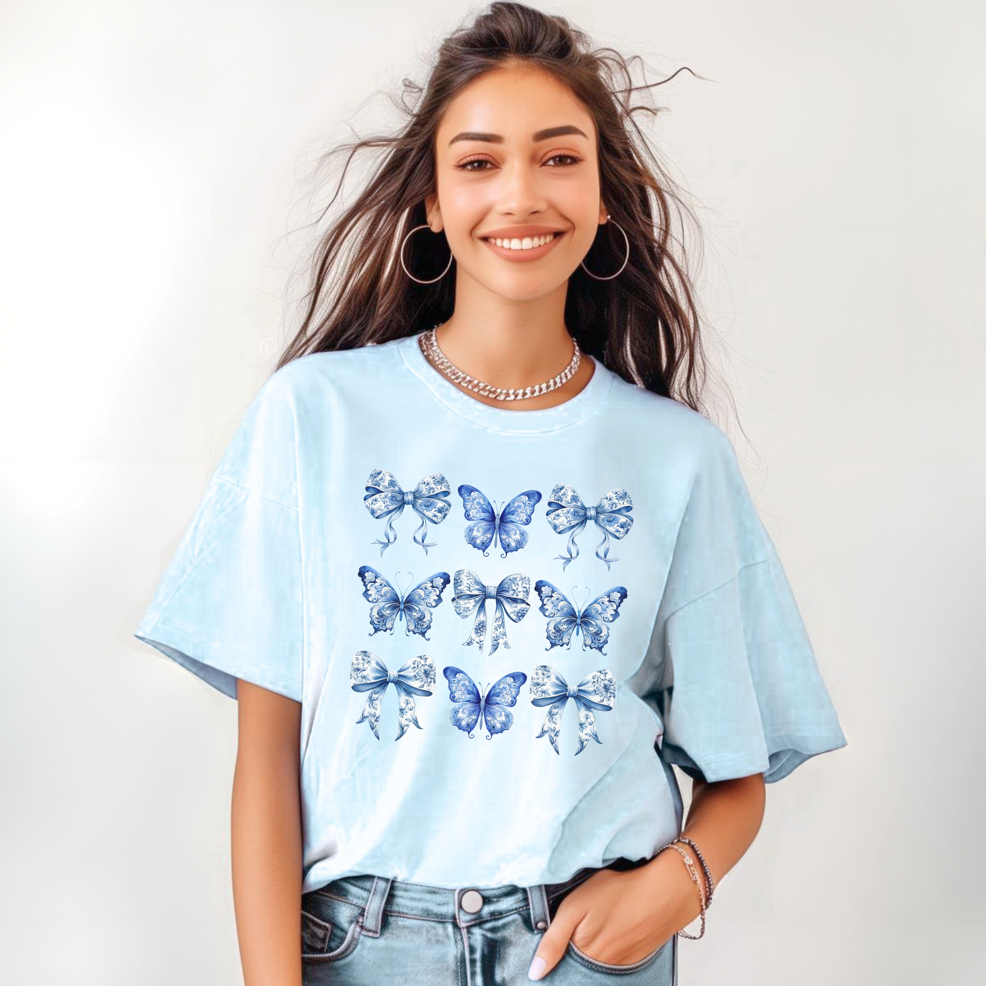 Image: Feminine and charming, this women’s blue toile shirt with butterflies and bows channels the soft girl aesthetic with a nod to French elegance. Designed with chinoiserie lovers and bougie mamas in mind, this piece brings vintage meets trendy style to your wardrobe. It’s part of a family matching set—available for toddlers and girls too—making it perfect for holidays, outings, or content shoots, by jaecrece.