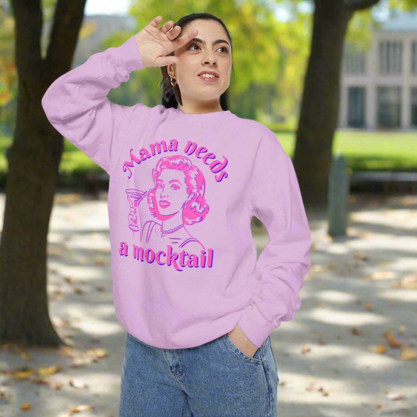Image: Mama Needs a Mocktail Sweatshirt. Comfort Colors Blossom. Hot pink neon graphic with a pop art mom holding a cocktail glass, with the text Mama Needs a Mocktail. Its a funny way to celebrate recovery in your life, or in the life of a friend, by jaecrece