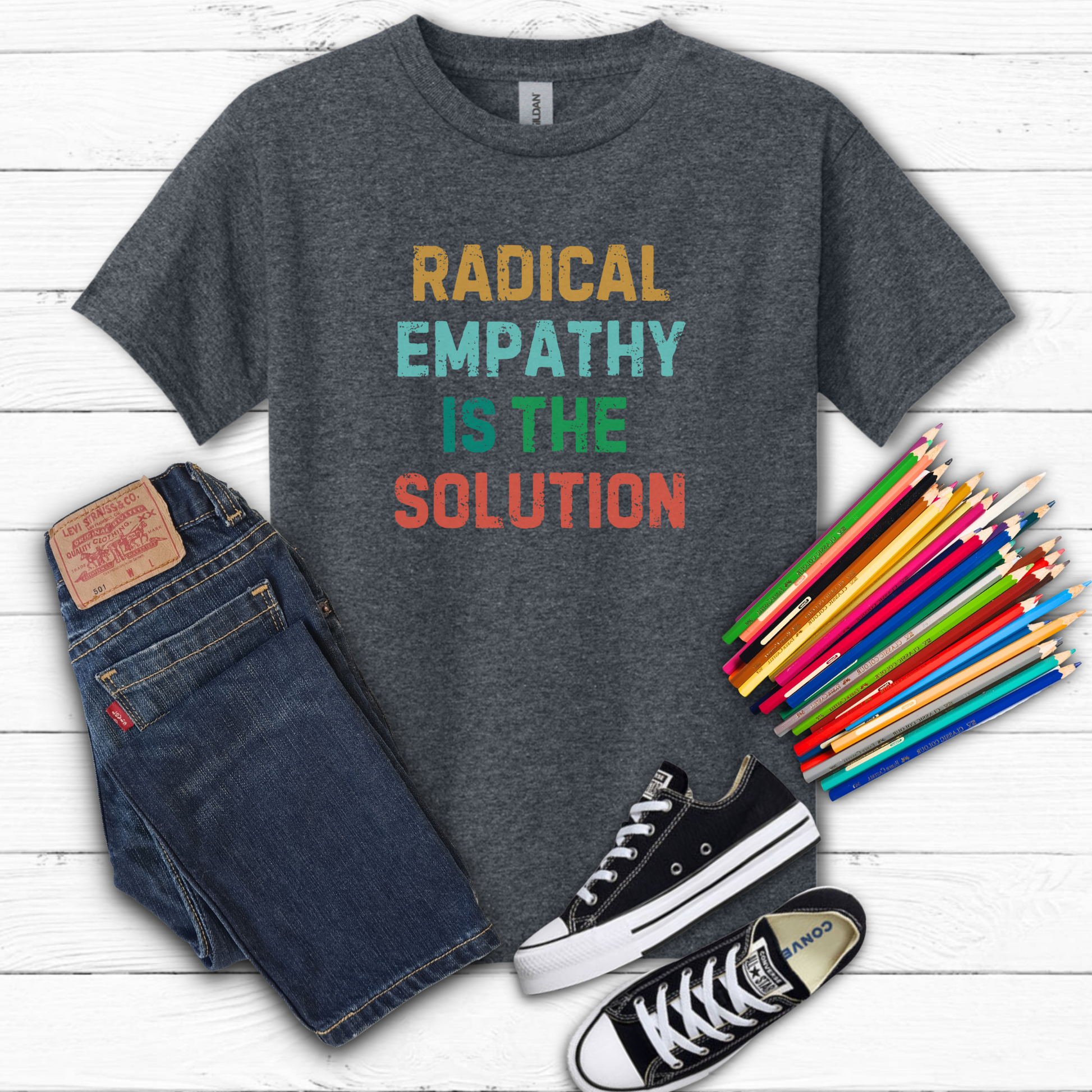 Image: A soft, comfortable kids' tee featuring the words "Radical Empathy is the Solution" in a bold, empowering design. Ideal for young activists, this shirt encourages kindness, understanding, and inclusivity. Whether for school, social events, or casual wear, this t-shirt helps kids express their values while staying stylish and comfortable, by jaecrece.