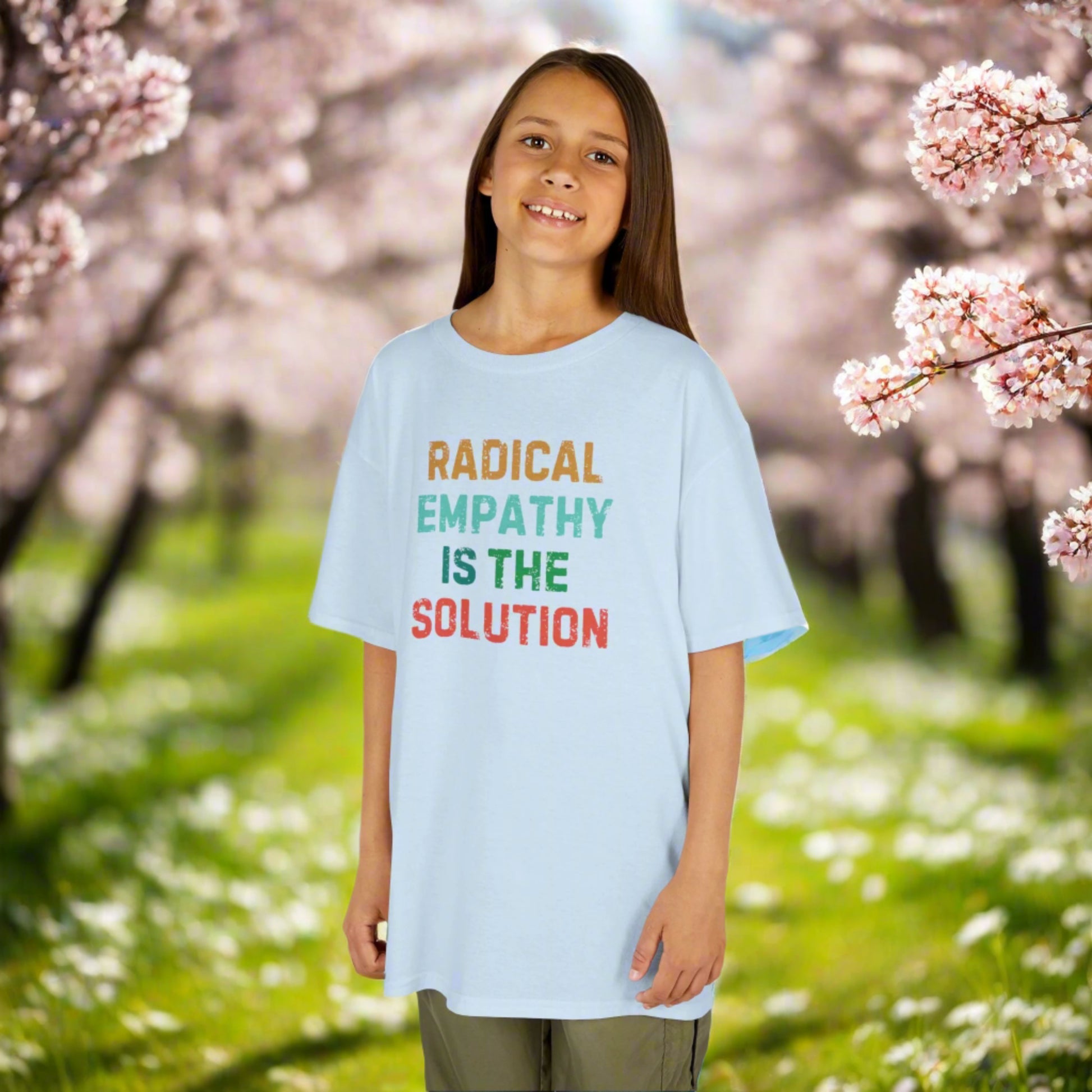 Image: Youth-sized activist t-shirt with the message "Radical Empathy is the Solution," a powerful statement for kids who care about equality and social justice. This shirt is a great way for children to express their support for kindness, neurodiversity, and mental health awareness. Made for young feminists, progressive thinkers, and future leaders, by jaecrece.
