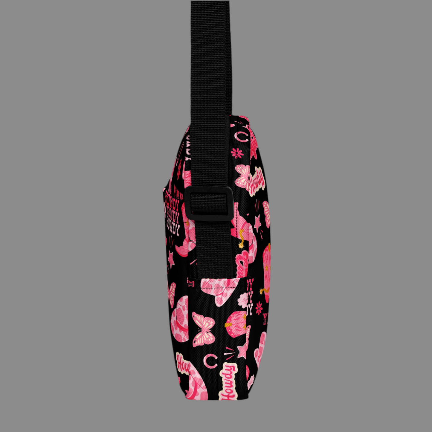 Image: Disco Cowgirl Canvas Crossbody Bag. This small black sling bag features a western glam hot pink pattern of cowgirl boots, cowgirl hats, butterflies and horseshoes. The pattern reads Disco Cowgirl, Yee-Haw and Howdy. The perfect mini backpack for bachelorette parties, gifts for teens or tweens, or trips to the state fair, by jaecrece