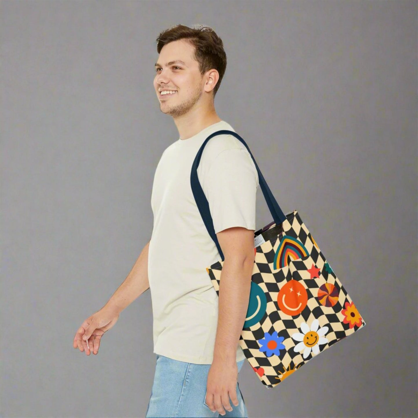 Smiley Face Checkerboard Canvas Tote Bag. This cute reusable carryall is eco friendly, and features a black and khaki checkerboard background, with smiley face, rainbow and daisy graphics. by jaecrece.com