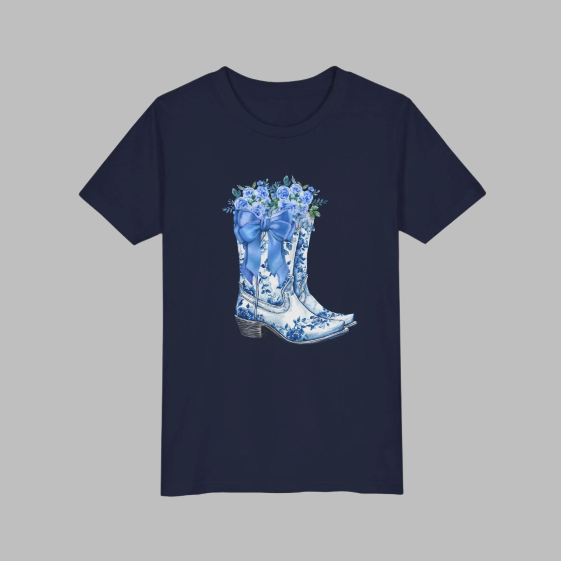 Image: Designed for girls in sizes S to XL, this country-chic sweatshirt features a whimsical scene of cowgirl boots, a blue ribbon, and floral accents. A coastal cowgirl favorite, this pullover adds just the right touch of southern sweetness to any outfit. Ideal for daughters who love soft blues, western vibes, and cozy statement pieces they can wear anywhere, by jaecrece.