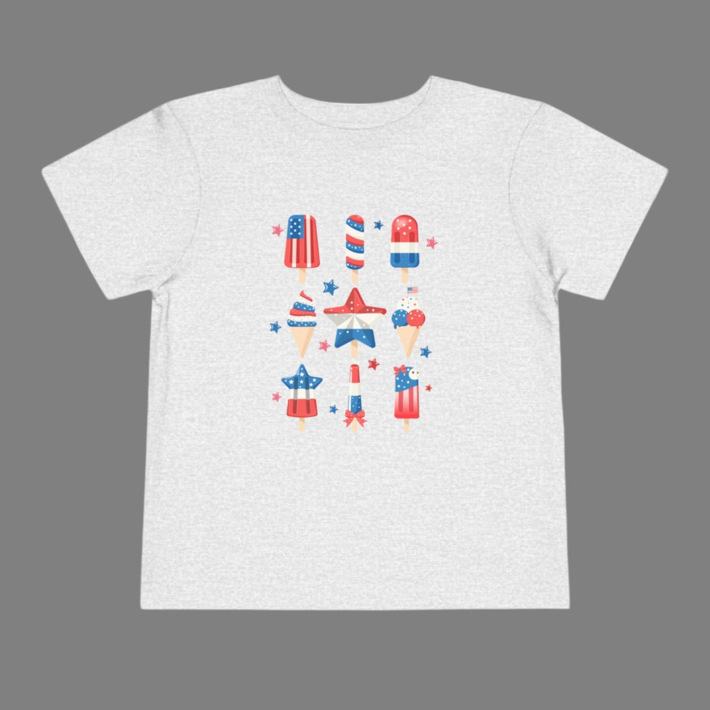 Image: Little ones will love this patriotic popsicle shirt in toddler sizes, made for Independence Day joy and summer comfort. Featuring a popsicle in red white and blue, this shirt is great for toddler holiday outfits, family barbecues, and Memorial Day celebrations. Capture sweet moments with your tiny firecracker in this adorable American themed tee, by jaecrece.