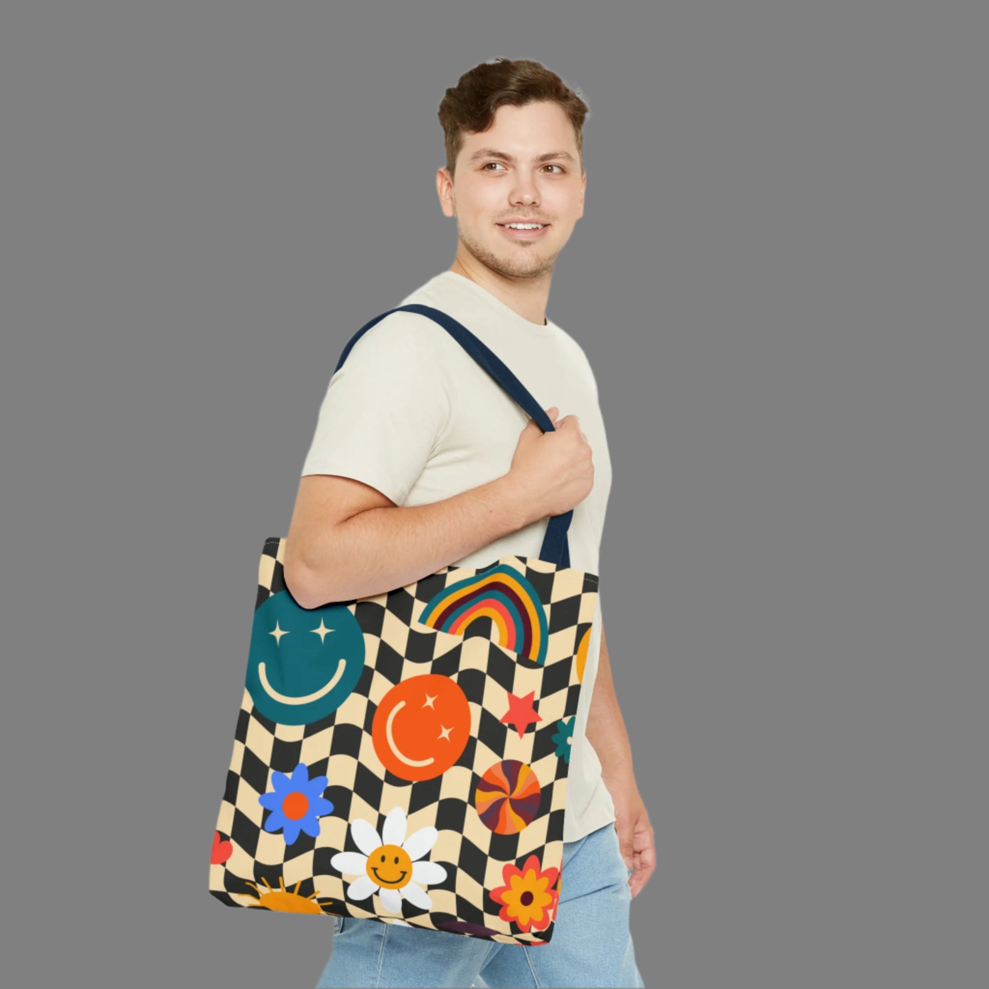 Smiley Face Checkerboard Canvas Tote Bag. This cute reusable carryall is eco friendly, and features a black and khaki checkerboard background, with smiley face, rainbow and daisy graphics. by jaecrece.com