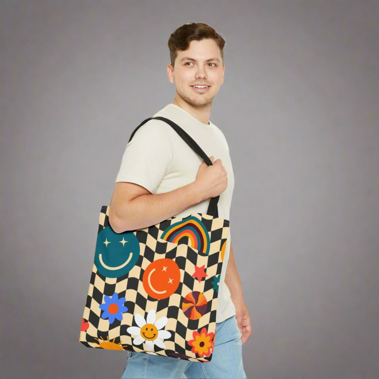 Smiley Face Checkerboard Canvas Tote Bag. This cute reusable carryall is eco friendly, and features a black and khaki checkerboard background, with smiley face, rainbow and daisy graphics. by jaecrece.com