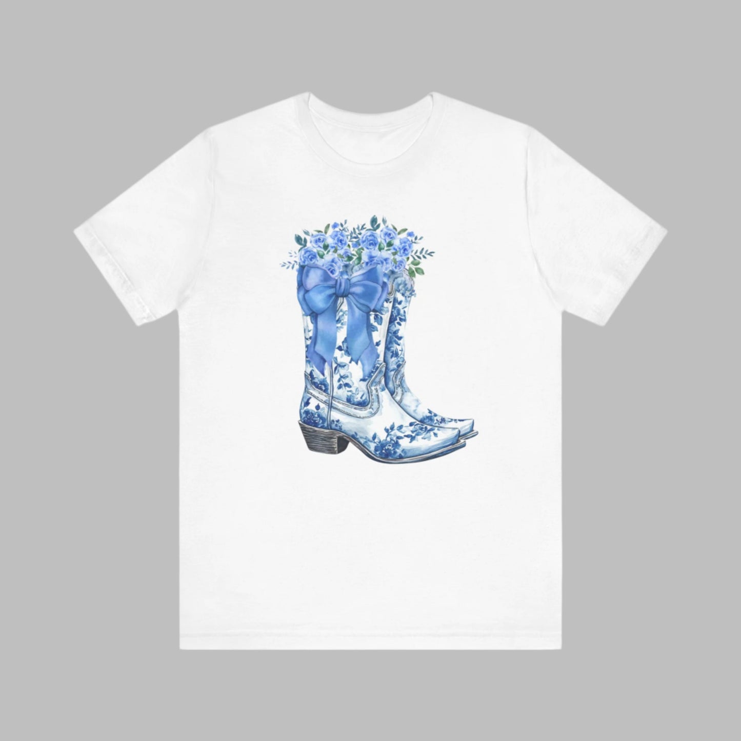 Image: Blue Toile Boots and Bows shirt in sizes for women. This pullover shirt features a pair of coastal cowgirl aesthetic cowboy boots with a blue bow and blue wildflowers. This country themed sweater makes a perfect gift for your daughter, or for the boujee mama in your life, by jaecrece