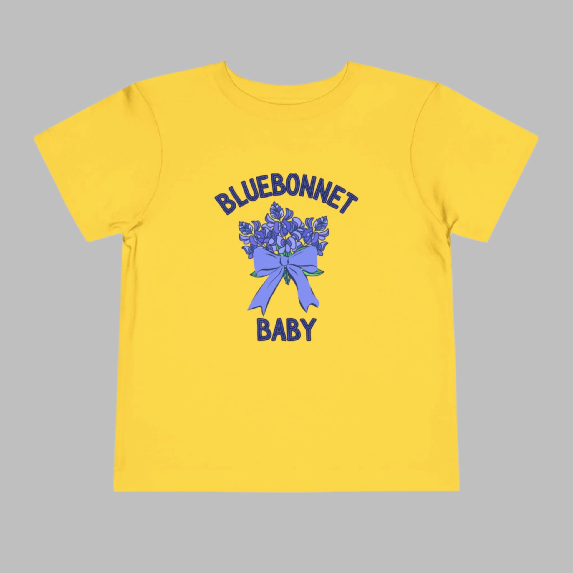 Image: A soft, breathable toddler t-shirt featuring a lovely bluebonnet print, celebrating the Texas state flower. Perfect for spring outings, this tee is ideal for bluebonnet field photos, playdates, or family picnics. A charming gift for baby showers or birthdays, it allows little Texans to embrace their roots. Its lightweight fabric ensures comfort while showcasing a nature-inspired design that makes any outfit extra special, by jaecrece.