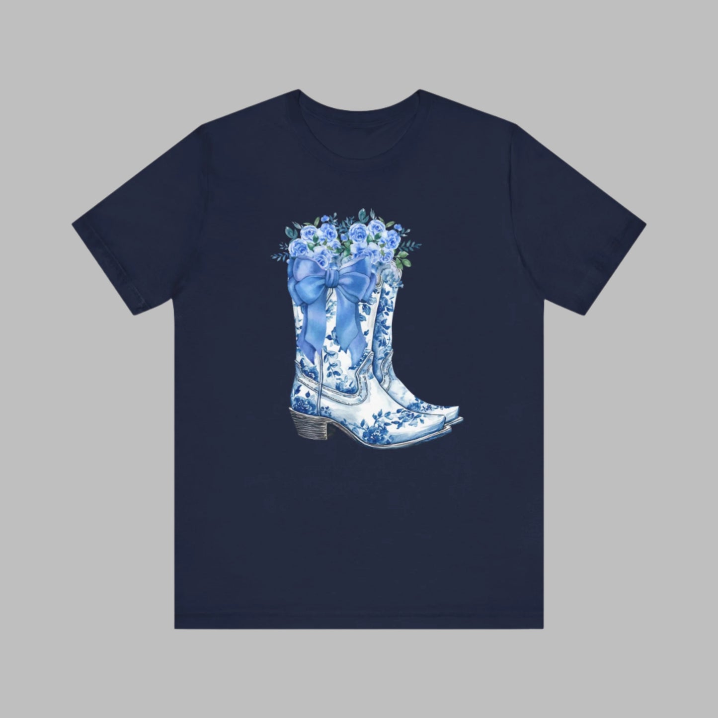 Image: Blue Toile Boots and Bows shirt in sizes for women. This pullover shirt features a pair of coastal cowgirl aesthetic cowboy boots with a blue bow and blue wildflowers. This country themed sweater makes a perfect gift for your daughter, or for the boujee mama in your life, by jaecrece