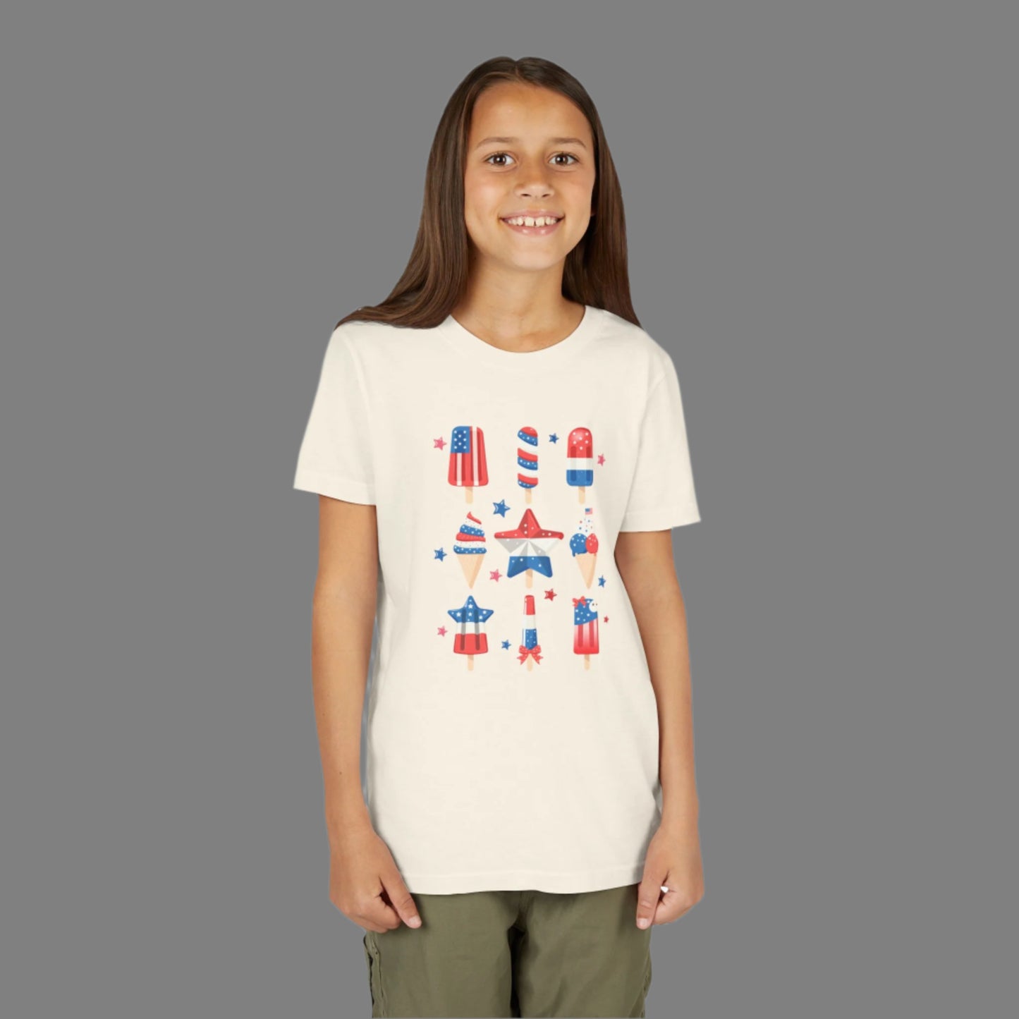 Image: Let your child celebrate summer in style with this patriotic popsicle shirt, available in youth sizes S through XL. The red white and blue design is ideal for the 4th of July, Memorial Day, and other American holidays. Whether worn at a parade, picnic, or just playing outside, this shirt is a fun and festive way to show off national pride, by jaecrece.