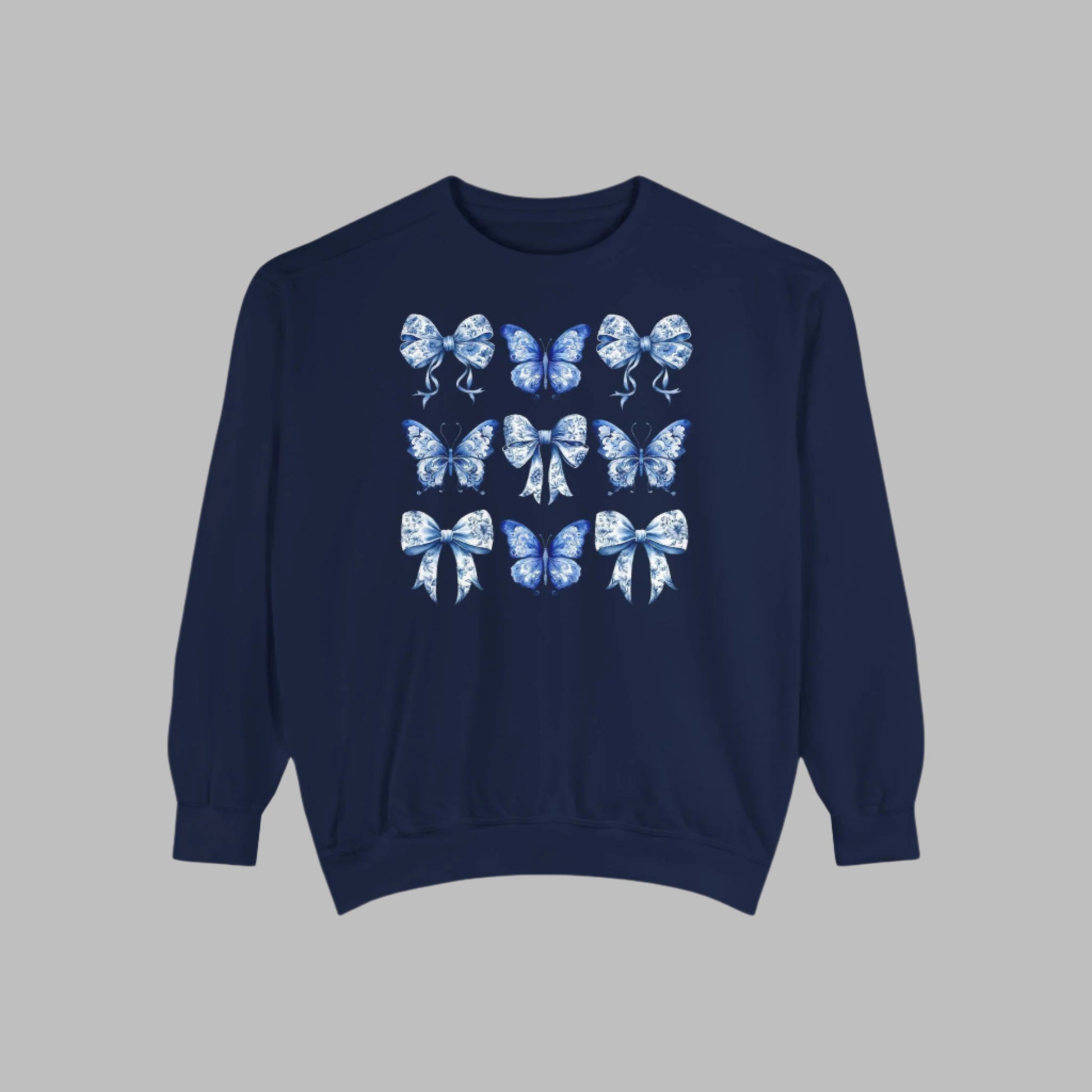 Image: Elegant yet comfortable sweatshirt for women with blue toile butterflies and bows, blending classic charm with modern softness. Sized XS to XL and designed for matching with toddlers and girls, this sweatshirt brings Texas coquette and coastal cowgirl fashion into the family wardrobe. A must-have for casual spring days, by jaecrece.