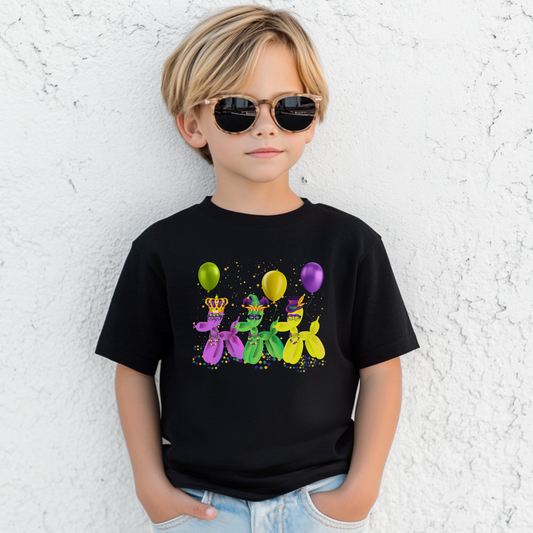 Youth black Mardi Gras t-shirt featuring three balloon dogs in purple, green, and gold wearing Carnival masks and hats. Perfect for parades in New Orleans or twirling through the French Quarter, this festive tee is made for family matching moments. A fun nod to "walk it like a dog" parade culture, it’s ideal for kids celebrating Mardi Gras in style with comfy, colorful, party-ready flair.