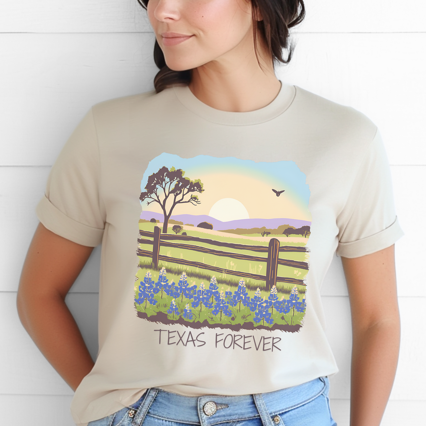 Image: A soft, comfortable T-shirt designed for those who love Texas and its stunning wildflowers. The graphic features a colorful field of bluebonnets under a mesmerizing sunset, with the words "Texas Forever" capturing the state's lasting beauty. Perfect for casual wear, Texas road trips, or as a meaningful gift for any Texas lover. Show off your Lone Star pride with this classic and timeless design, by jaecrece.