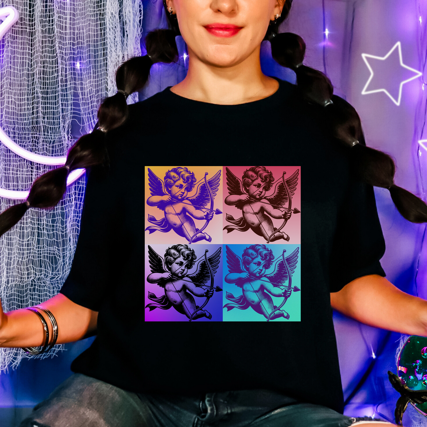 Cupid tee for adults available in XS to 5XL in classic Valentine colors: pink, black, and white. Features a retro-inspired pop art Cupid floating in the clouds, printed on soft cotton. Perfect for men or women who want a playful, artsy Valentine’s look. Coordinates with matching toddler and youth tees for a full family Valentine’s Day set with nostalgic vibes and cozy feel.