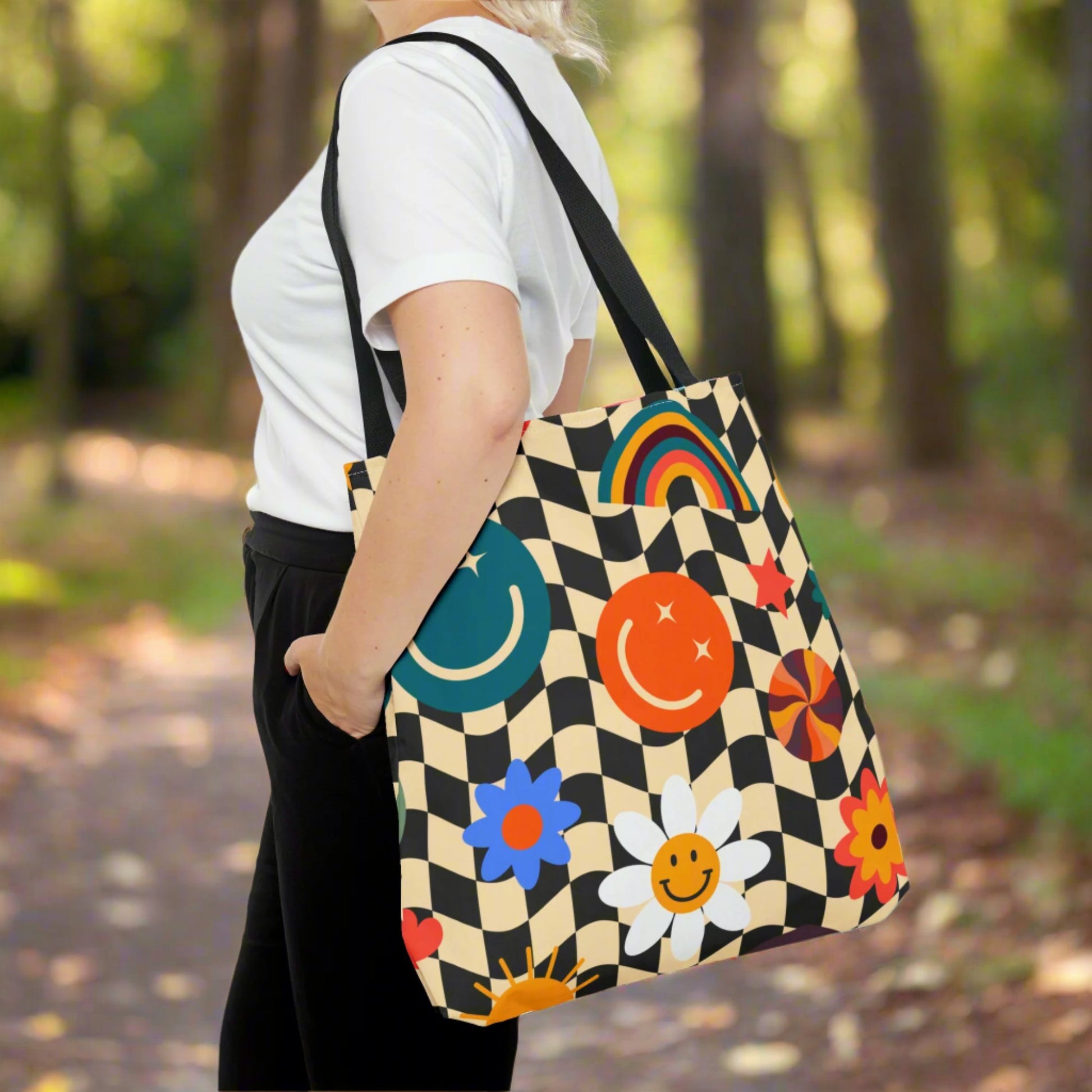 Smiley Face Checkerboard Canvas Tote Bag. This cute reusable carryall is eco friendly, and features a black and khaki checkerboard background, with smiley face, rainbow and daisy graphics. by jaecrece.com