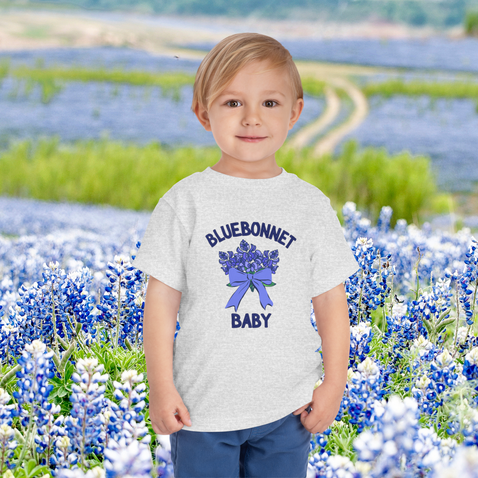 Image: Celebrate Texas wildflowers with this charming bluebonnet baby shirt. This soft toddler tee captures the essence of spring with its floral design, perfect for Easter gatherings, family photos, or trips to the bluebonnet fields. Ideal for little Texans who love nature, this shirt makes a thoughtful baby shower gift or birthday present. Let your child bloom in this sweet Texas-inspired outfit that showcases state pride and natural beauty, by jaecrece.