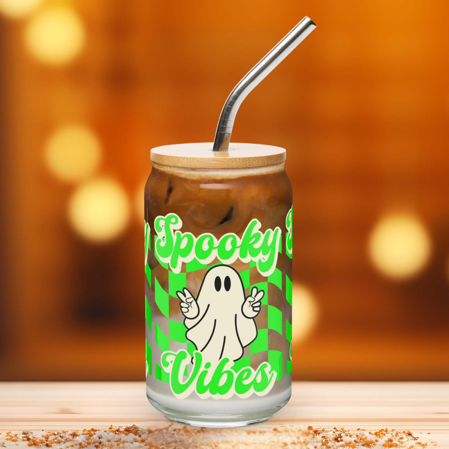 Surrounded by pumpkins and cozy fall décor, this Spooky Vibes sipper glass is a festive addition to your Halloween kitchen setup. The cute ghost, bamboo lid, and vivid neon checkerboard pattern make it a standout in seasonal drinkware. Great for social media-worthy setups, gift baskets, or your autumn beverage routine, it’s a must-have for Halloween lovers and iced coffee girlies.
