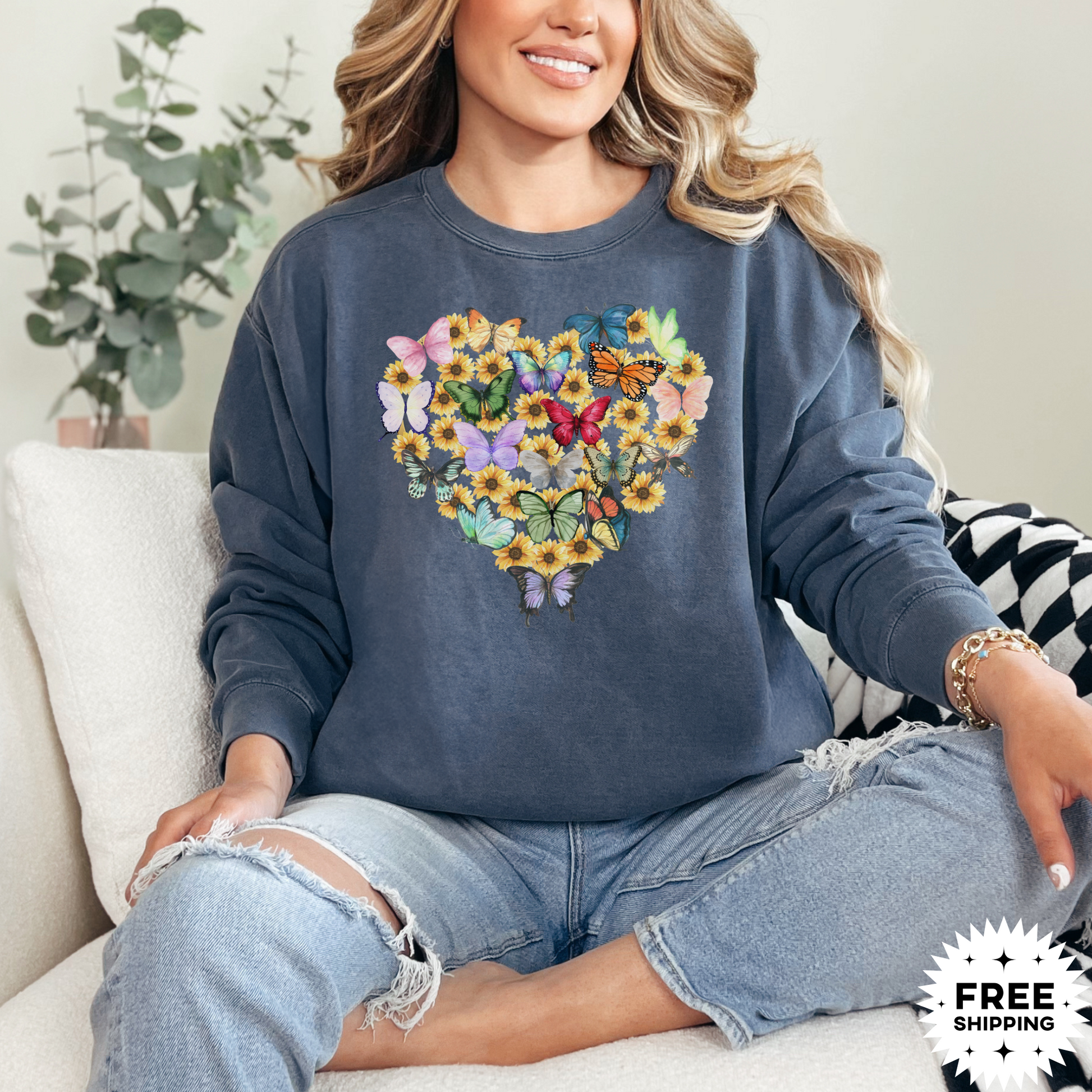 Image: Butterfly Sunflower Heart Womens Sweatshirt. This nature inspired cozy pullover sweatshirt has  watercolor wildflowers and butterflies. Comfort colors available in violet, Blue spruce and denim. Great for Earth Day, Valentines Day, by jaecrece