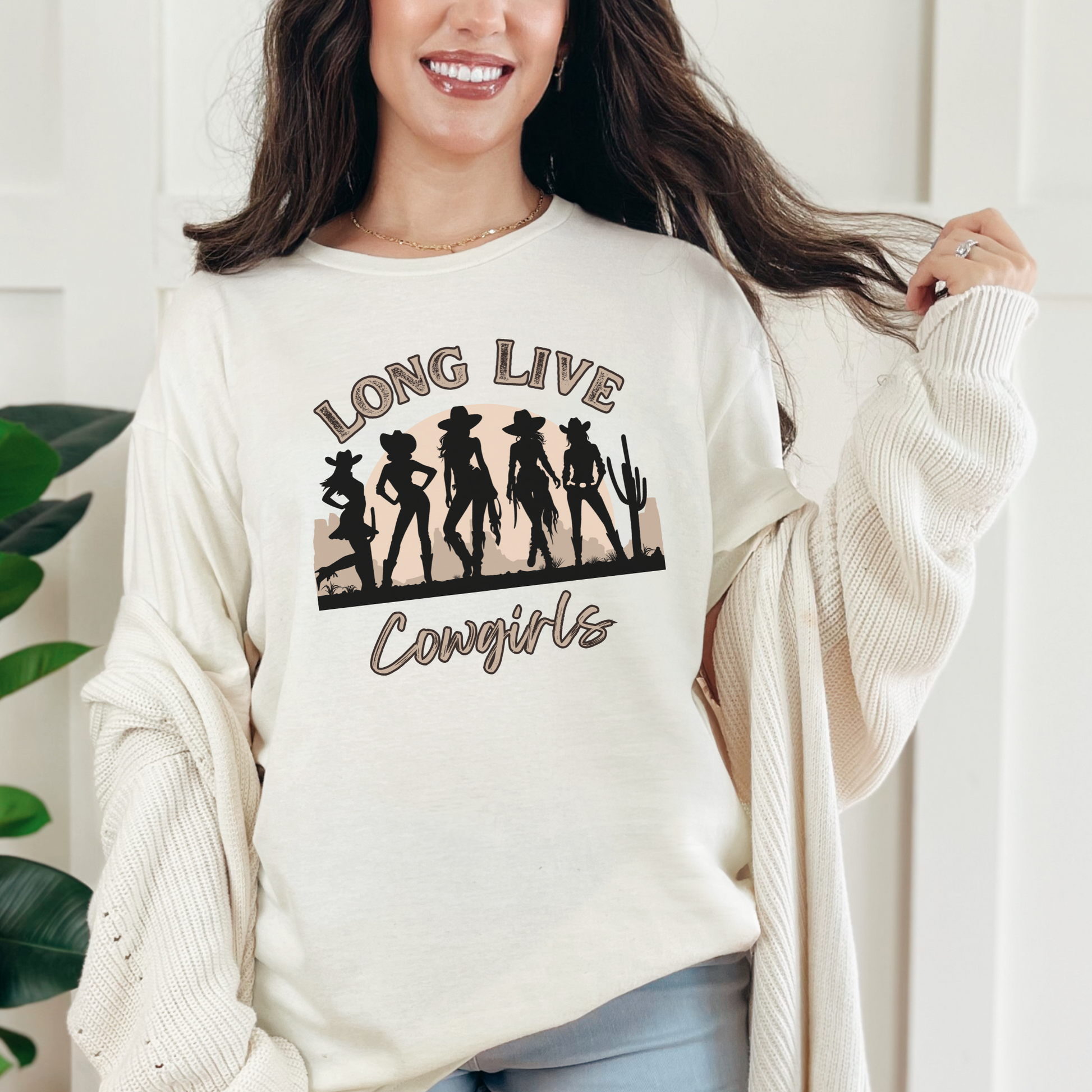 Image: Capture the essence of the wild west with this oversized cowgirl t-shirt, showcasing five cowgirl silhouettes in a desert scene with the bold phrase Long Live Cowgirls. A stylish nod to country music, rodeo culture, and western fashion, this retro-inspired tee is perfect for outdoor adventures, concerts, or laid-back country nights. A thoughtful gift for cowgirls who love vintage charm, by jaecrece.