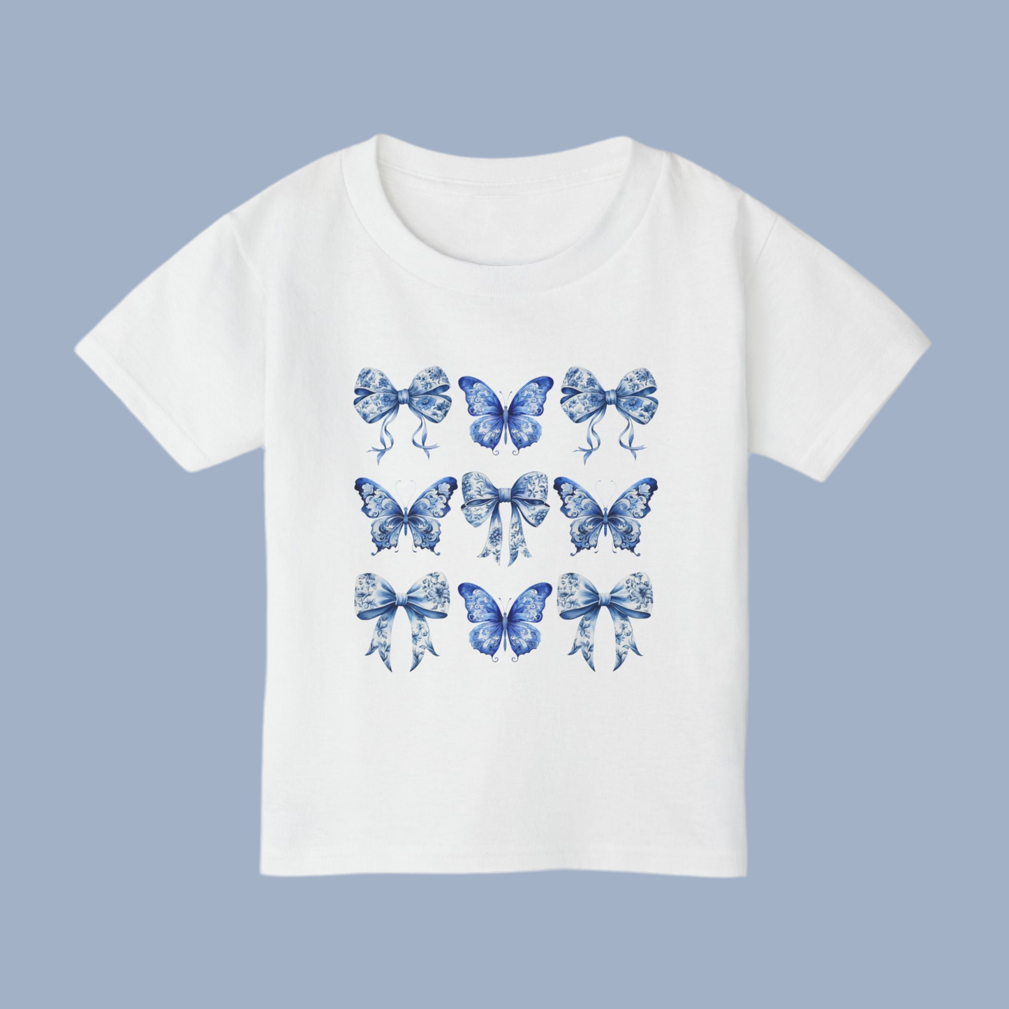 Blue Toile toddler tee for girls features a classic butterfly and bow motif in soft blue hues, perfect for fans of cottagecore, Texas coquette trends, and coastal cowgirl style. Designed for comfort and charm, this cute spring shirt for toddlers is ideal for everyday play or family matching moments. Sizes 2T to 6T make it easy to twin with older siblings or moms. An aesthetic, versatile gift for fashionable little ones, by jaecrece.