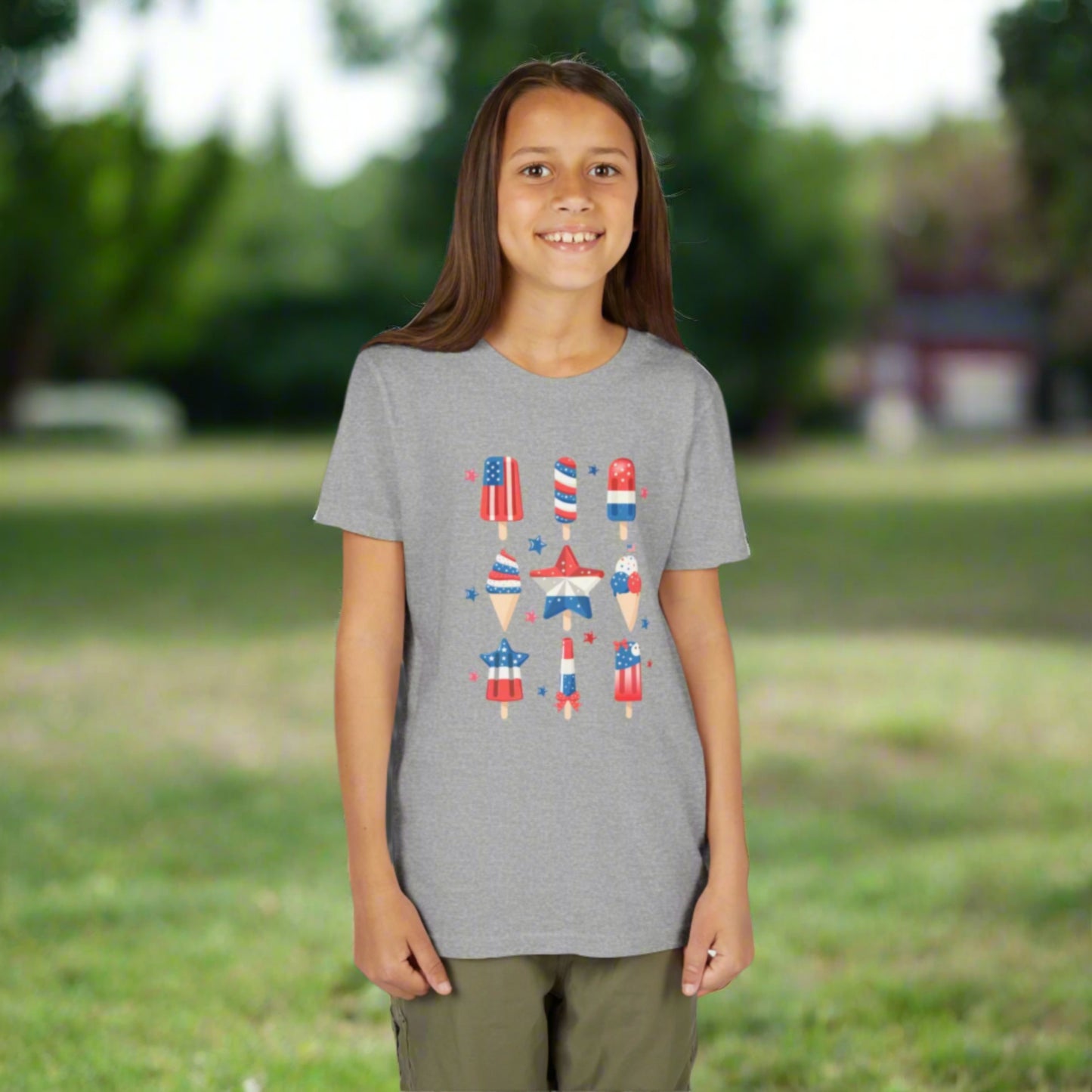 Image: Let your child show off their American spirit with this patriotic popsicle shirt, available in child sizes S through XL. The cute frozen treat design and soft cotton fabric make it an instant favorite for 4th of July parades, backyard barbecues, or school holiday programs. A great match with red shorts or jeans, by jaecrece.