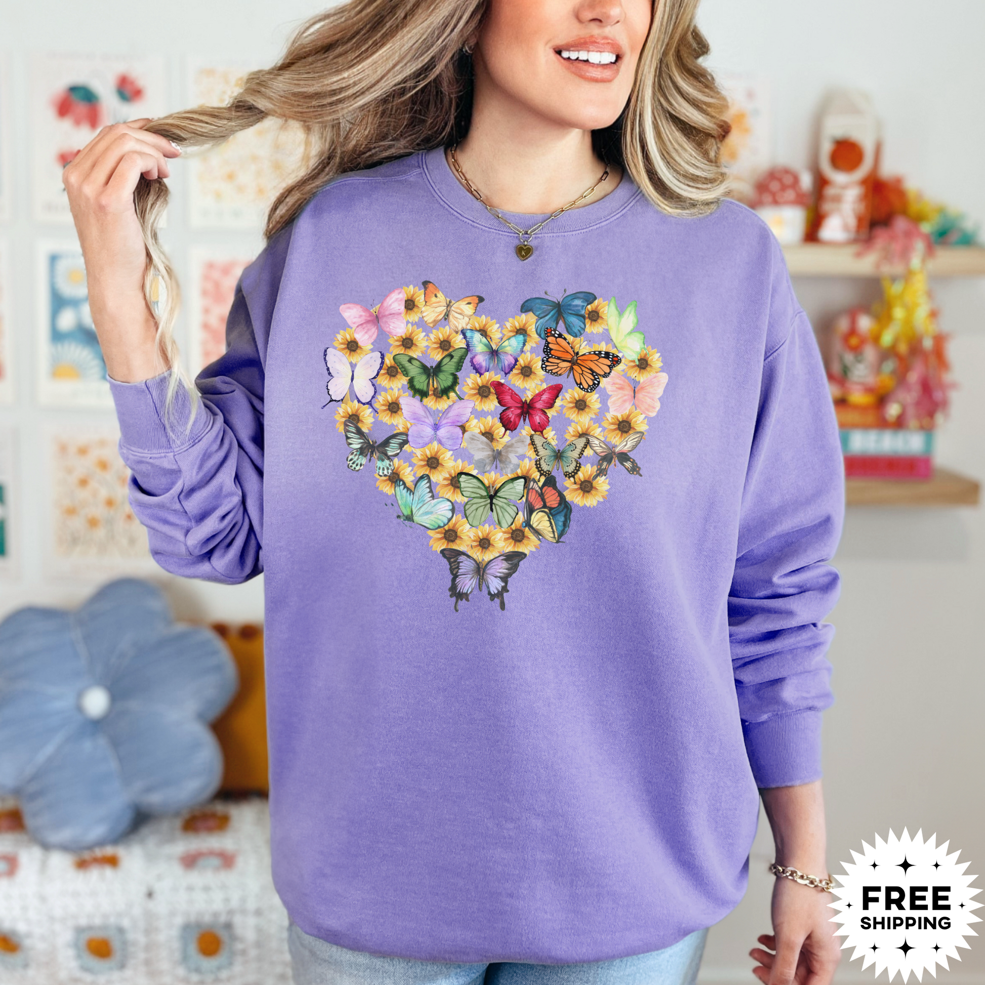 Image: Butterfly Sunflower Heart Womens Sweatshirt. This nature inspired cozy pullover sweatshirt has  watercolor wildflowers and butterflies. Comfort colors available in violet, Blue spruce and denim. Great for Earth Day, Valentines Day, by jaecrece