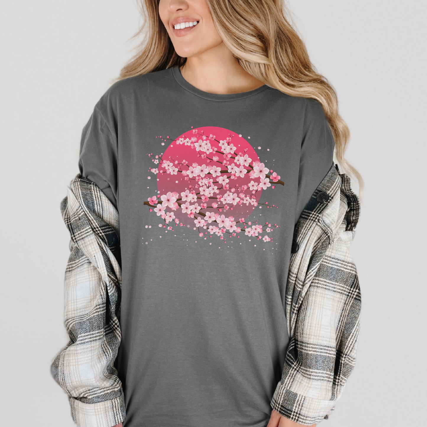 Image: A pink cherry blossom t-shirt featuring a delicate sakura tree design. The soft, durable fabric offers comfort, while the classic fit makes it versatile for any occasion. Perfect for springtime celebrations, Japanese aesthetic lovers, and those who appreciate kawaii fashion. Ideal as a gift for teens and adults.