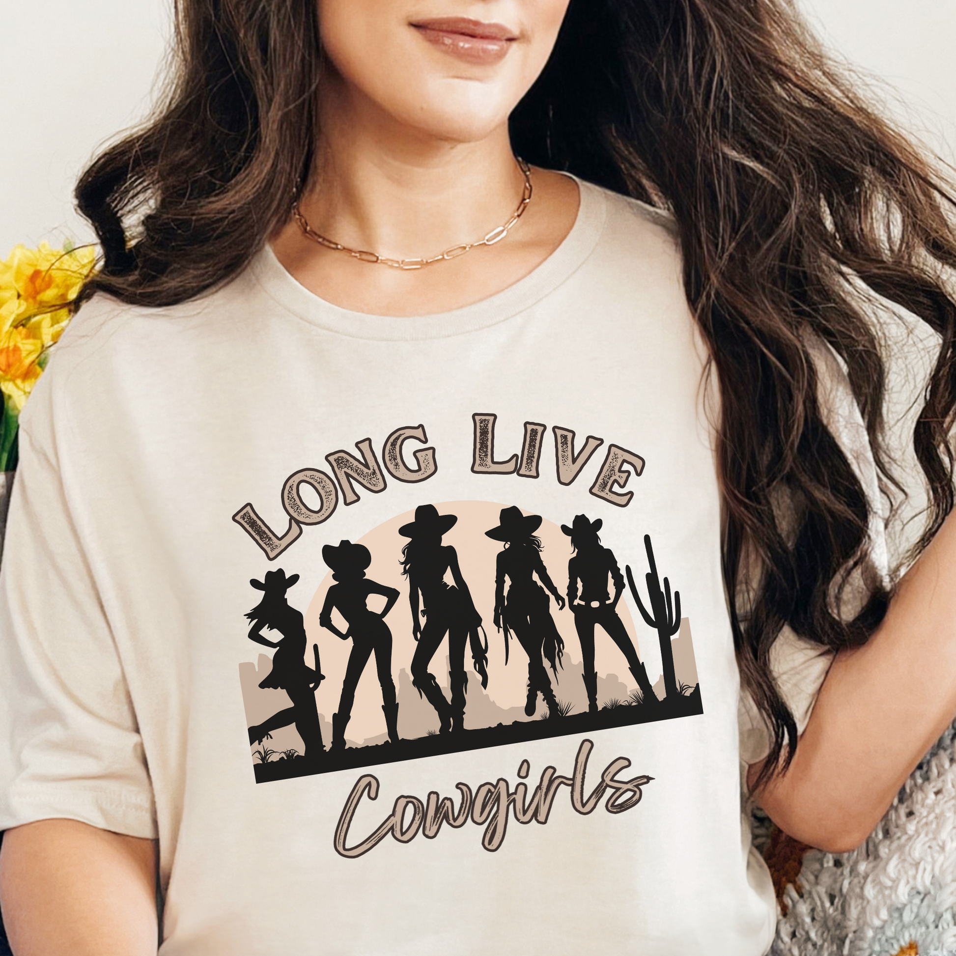Image: A soft, oversized country tee with Long Live Cowgirls printed above five bold cowgirl figures, bringing vintage western style to life. The relaxed fit and earthy tones make it the perfect choice for music festivals, rodeos, and everyday country wear. Whether you are a true western spirit or just love rustic fashion, this shirt blends comfort and charm effortlessly, by jaecrece.