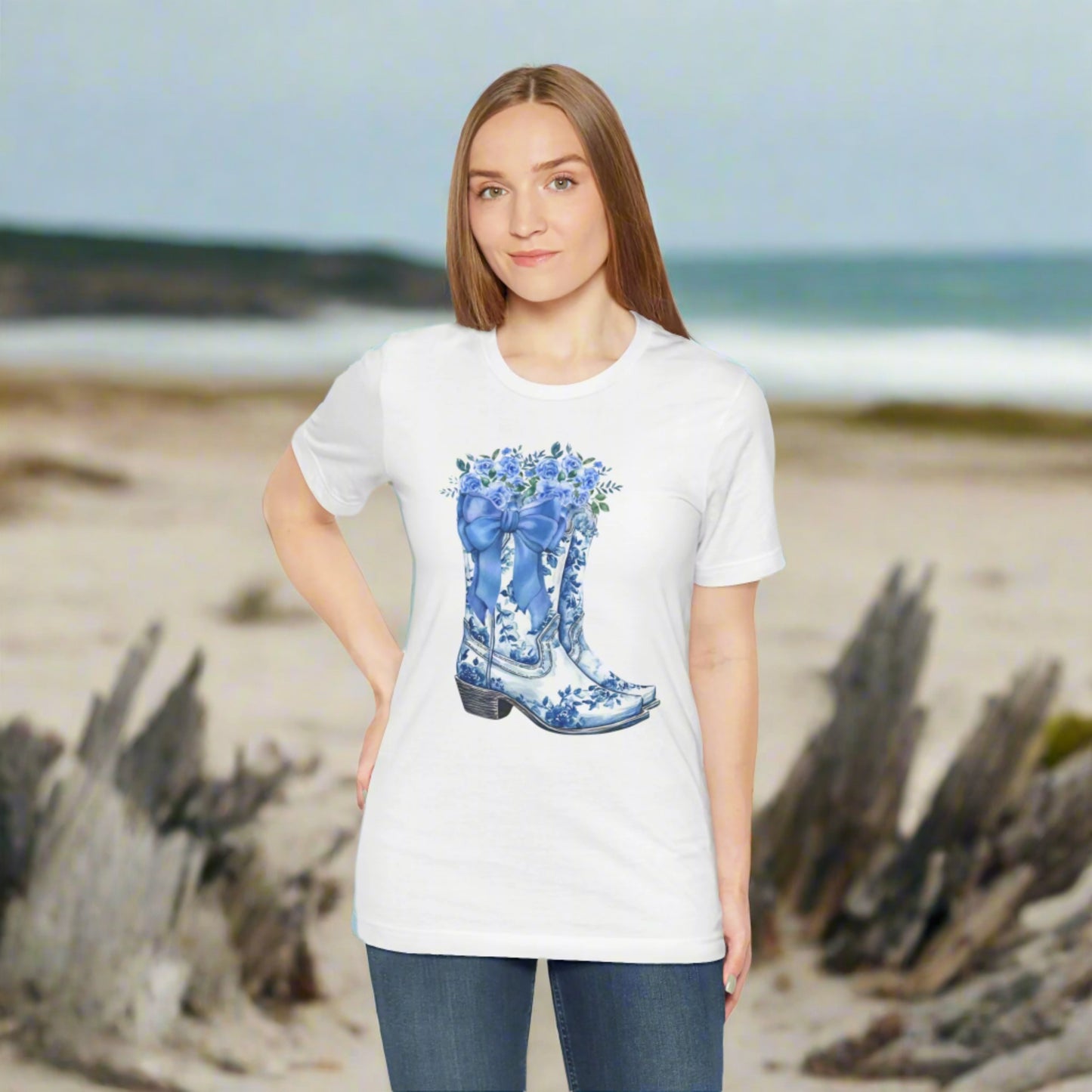Image: Blue Toile Boots and Bows shirt in sizes for women. This pullover shirt features a pair of coastal cowgirl aesthetic cowboy boots with a blue bow and blue wildflowers. This country themed sweater makes a perfect gift for your daughter, or for the boujee mama in your life, by jaecrece