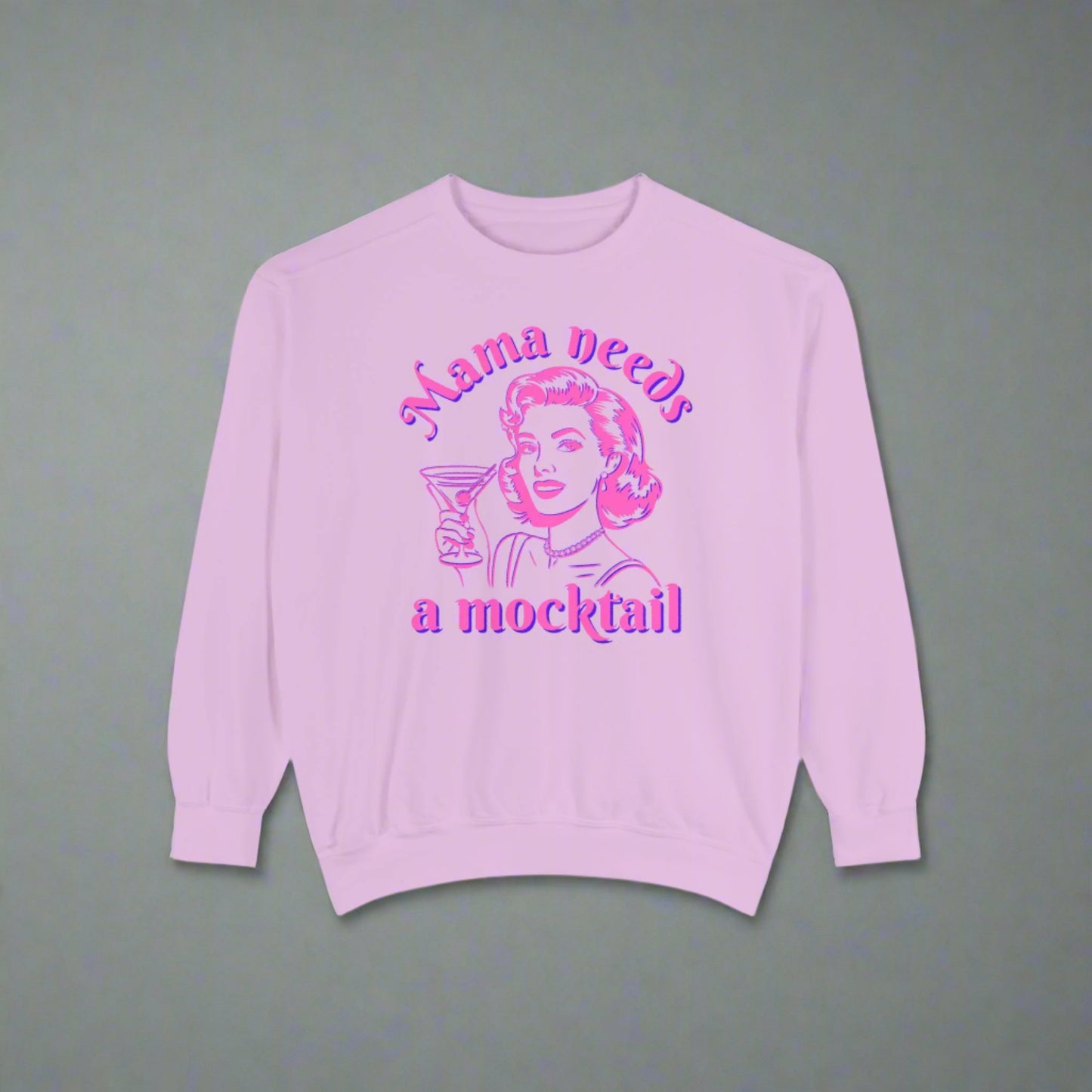 Image: Mama Needs a Mocktail Sweatshirt. Comfort Colors Blossom. Hot pink neon graphic with a pop art mom holding a cocktail glass, with the text Mama Needs a Mocktail. Its a funny way to celebrate recovery in your life, or in the life of a friend, by jaecrece