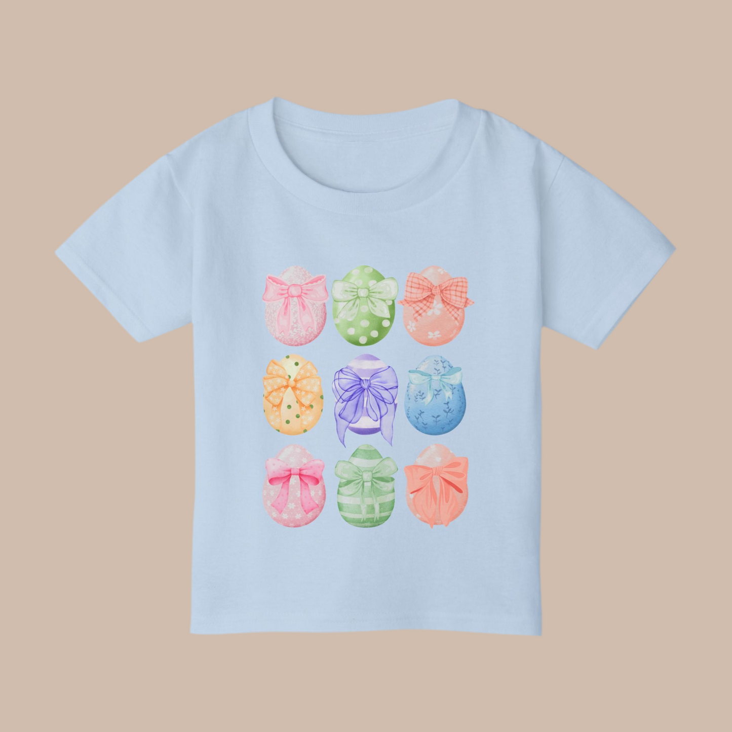 Image: Celebrate Easter with this adorable toddler shirt featuring nine watercolor eggs, each decorated with a dainty bow in coordinating pastel shades. This soft and stylish tee is perfect for spring festivities, making it an ideal choice for egg hunts, Easter brunch, and matching family outfits. With a charming design and cozy fit, this Easter tee is a wonderful gift idea and a great addition to any little girl’s wardrobe, by jaecrece.