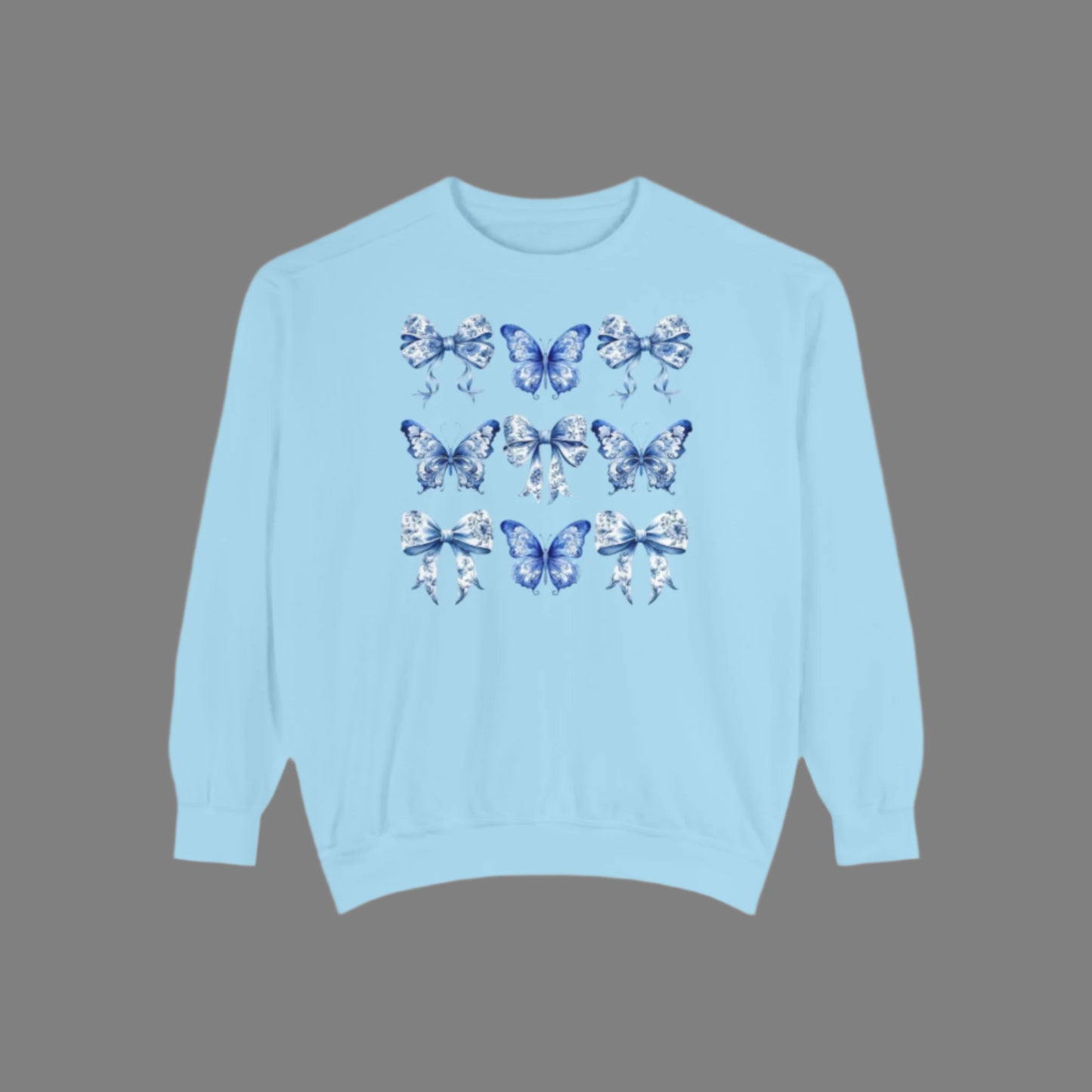Image: Elegant yet comfortable sweatshirt for women with blue toile butterflies and bows, blending classic charm with modern softness. Sized XS to XL and designed for matching with toddlers and girls, this sweatshirt brings Texas coquette and coastal cowgirl fashion into the family wardrobe. A must-have for casual spring days, by jaecrece.
