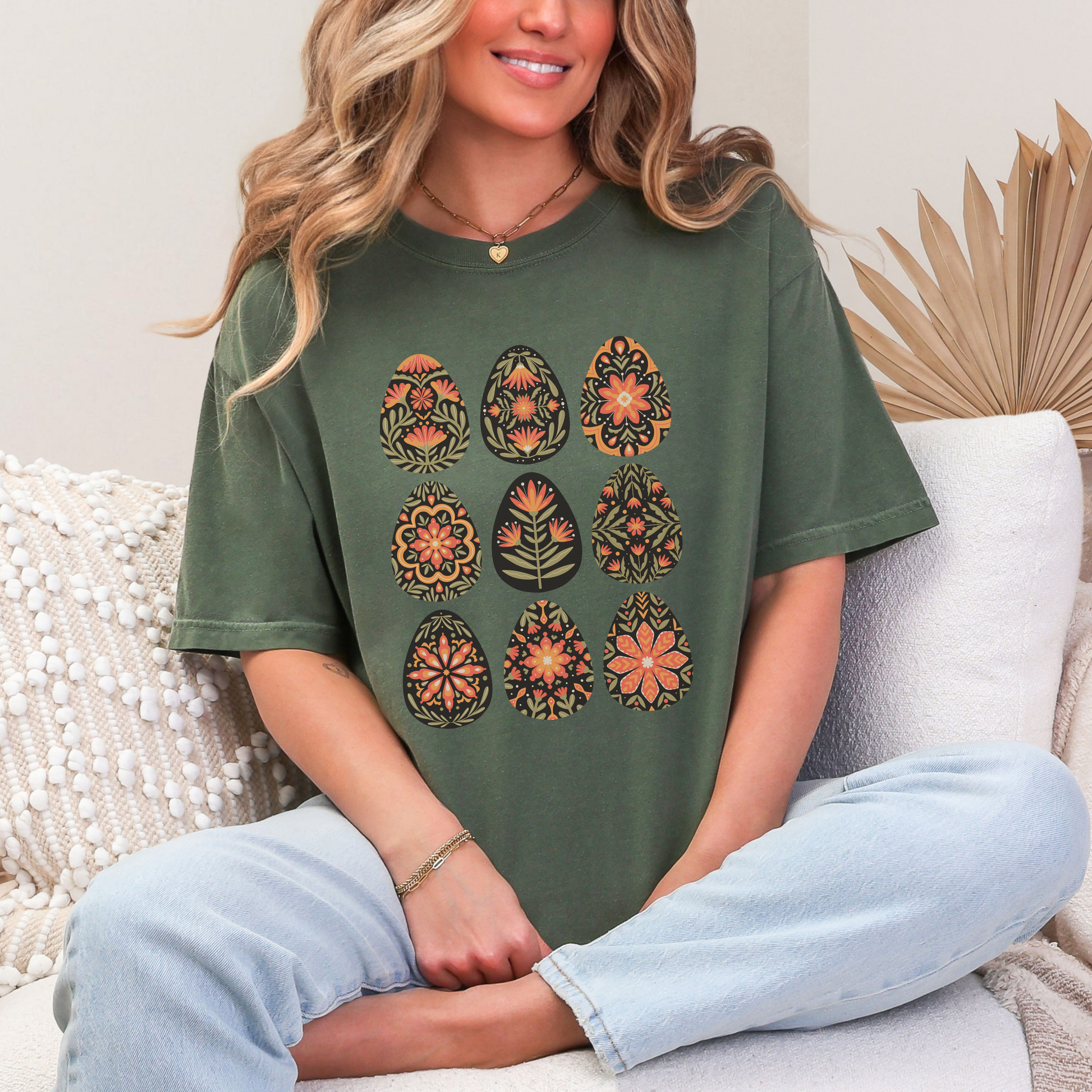 Image: A soft, comfortable t-shirt showcasing a unique folk art Easter egg print with intricate floral patterns. Inspired by vintage Scandinavian and Polish folk designs, this botanical shirt captures the charm of spring and cottagecore fashion. The boho floral aesthetic and subtle vintage tones make it an ideal choice for those who love Nordic traditions and artistic Easter themes. A perfect gift for women who appreciate cozy, nature-inspired styles, by jaecrece.