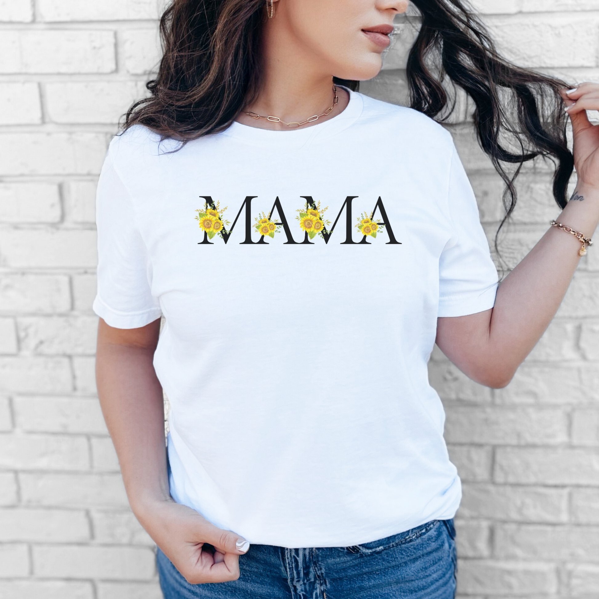 Soft and stylish Mama shirt decorated with blooming sunflowers across black-lettered typography. This cozy graphic tee is perfect for moms who love florals, sunflowers, or nature-themed apparel. A heartfelt piece for everyday wear or special occasions like baby showers, Mother's Day, or family photo shoots. Designed to bring sunshine into every mama’s wardrobe.