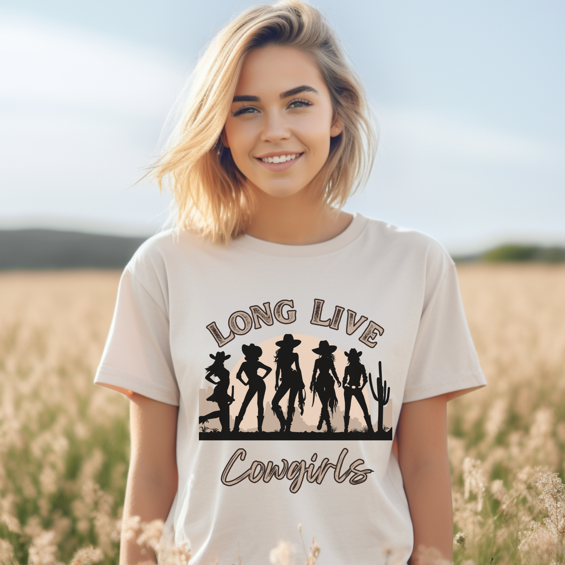 Image: Show off your cowgirl spirit with this oversized western t-shirt, designed with a retro desert landscape and five fierce cowgirl silhouettes. The Long Live Cowgirls; message is perfect for country music fans, Nashville lovers, and rodeo-goers looking for a stylish yet comfortable outfit. This classic western graphic tee makes a fantastic gift for any free-spirited cowgirl, by jaecrece.