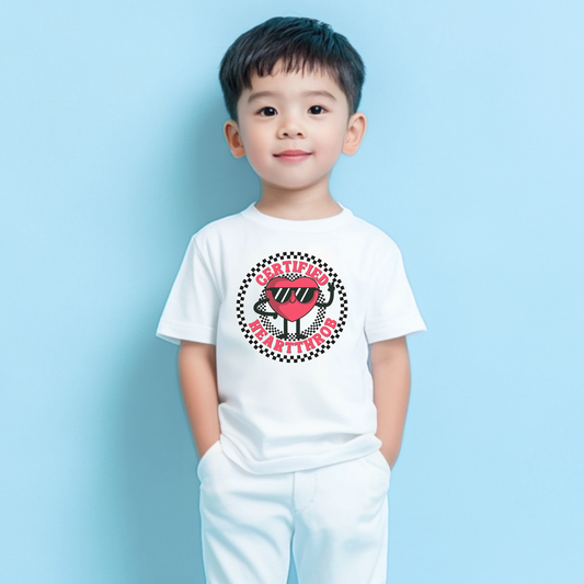 Image: Certified Heartthrob Tshirt. This Valentines Day tee for boys or girls is available in white or gray. It features a checker pattern ring, with a cartoon heart man wearing sunglasses, with the text Certified Heartthrob, by jaecrece