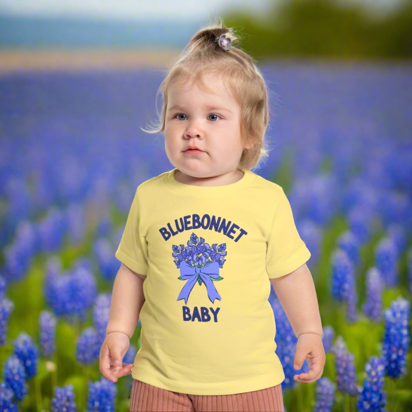 Image: A soft, breathable toddler t-shirt featuring a lovely bluebonnet print, celebrating the Texas state flower. Perfect for spring outings, this tee is ideal for bluebonnet field photos, playdates, or family picnics. A charming gift for baby showers or birthdays, it allows little Texans to embrace their roots. Its lightweight fabric ensures comfort while showcasing a nature-inspired design that makes any outfit extra special, by jaecrece.