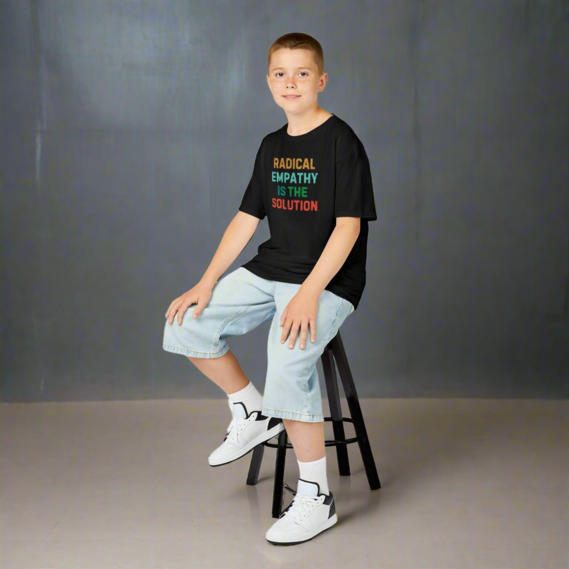 Image: A soft, comfortable kids' tee featuring the words "Radical Empathy is the Solution" in a bold, empowering design. Ideal for young activists, this shirt encourages kindness, understanding, and inclusivity. Whether for school, social events, or casual wear, this t-shirt helps kids express their values while staying stylish and comfortable, by jaecrece.