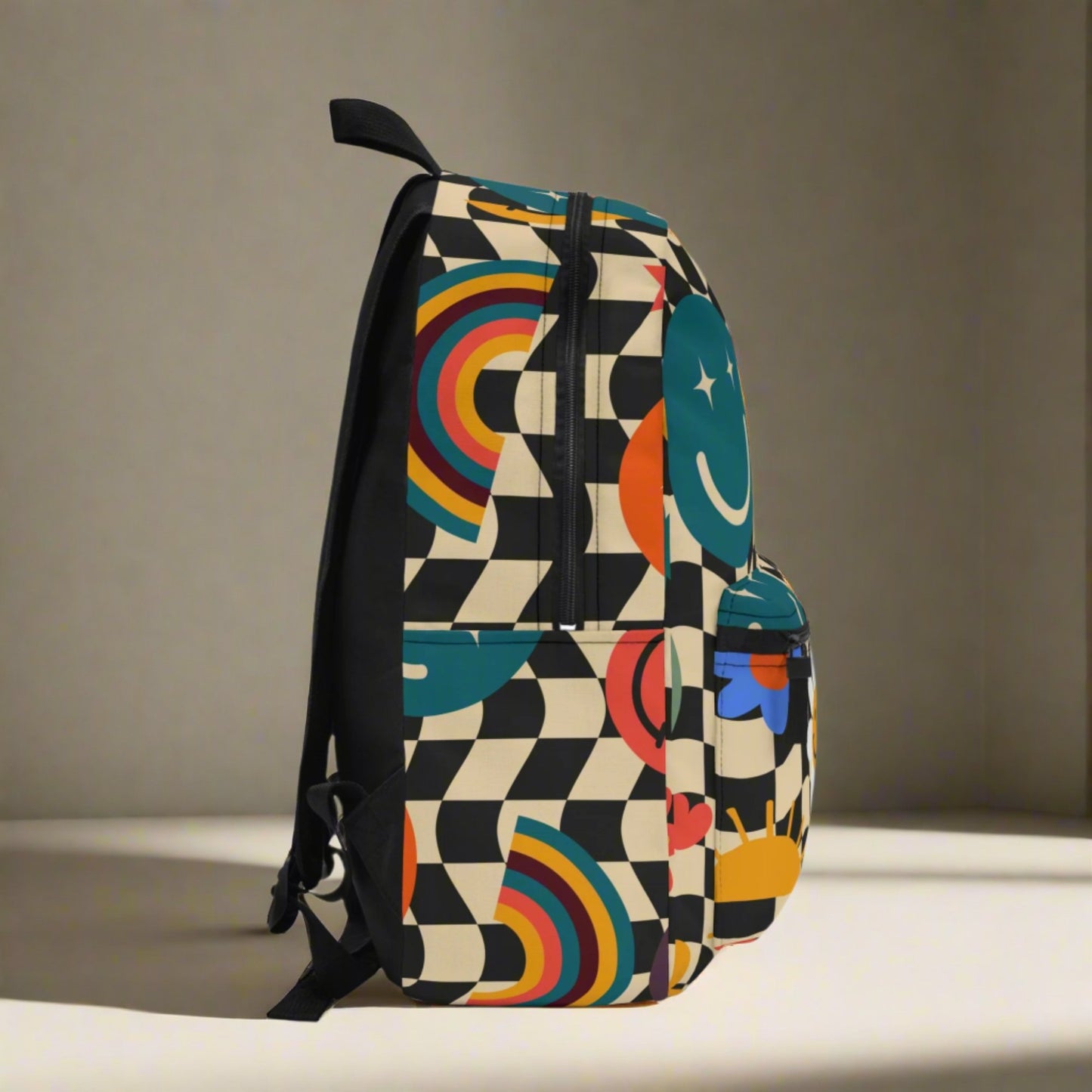 Image: Smiley Face Retro Checkerboard Backpack, with a black and tan checker pattern, and daisies, rainbows, suns and stars. The perfect vintage back to school bookbag for your hippie chick teen or tween, by jaecrece