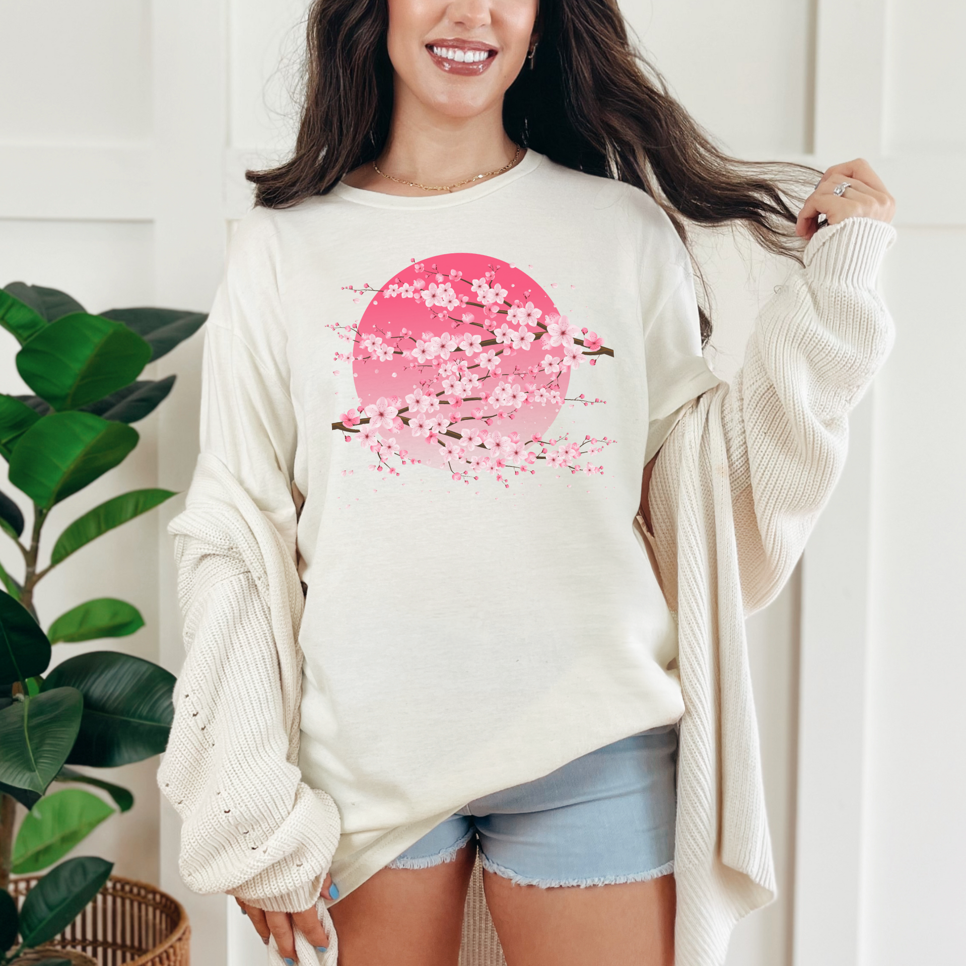 Image: A pink cherry blossom t-shirt featuring a delicate sakura tree design. The soft, durable fabric offers comfort, while the classic fit makes it versatile for any occasion. Perfect for springtime celebrations, Japanese aesthetic lovers, and those who appreciate kawaii fashion. Ideal as a gift for teens and adults.