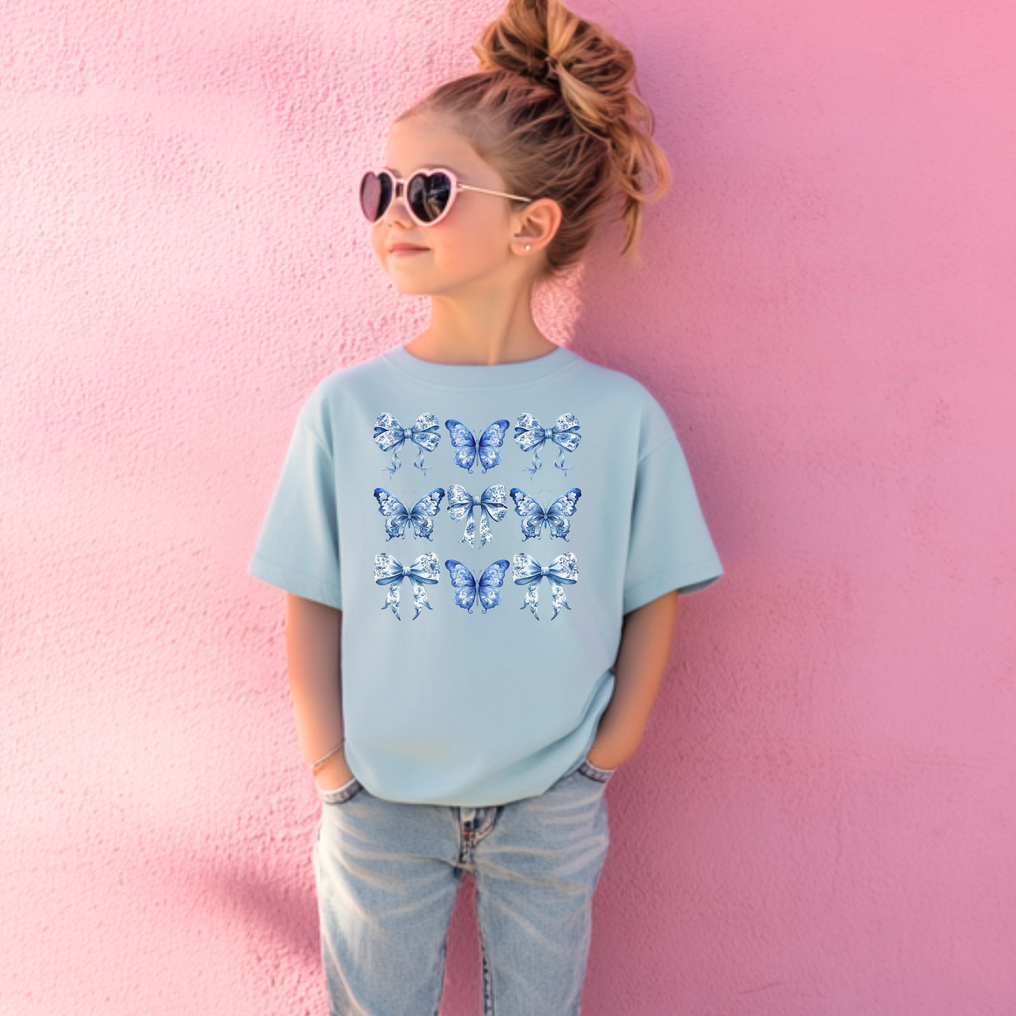 Adorable toddler girl T-shirt in soft cotton showcases a vintage blue toile design with butterflies and bows, channeling the popular Texas coquette and coastal cowgirl aesthetics. This stylish toddler tee is a wardrobe essential for spring outings, western-themed parties, and sibling matching looks. Available in sizes 2T, 3T, 4T, 5T, and 6T, it makes an excellent gift for southern sweethearts or beachy boho babies, by jaecrece.
