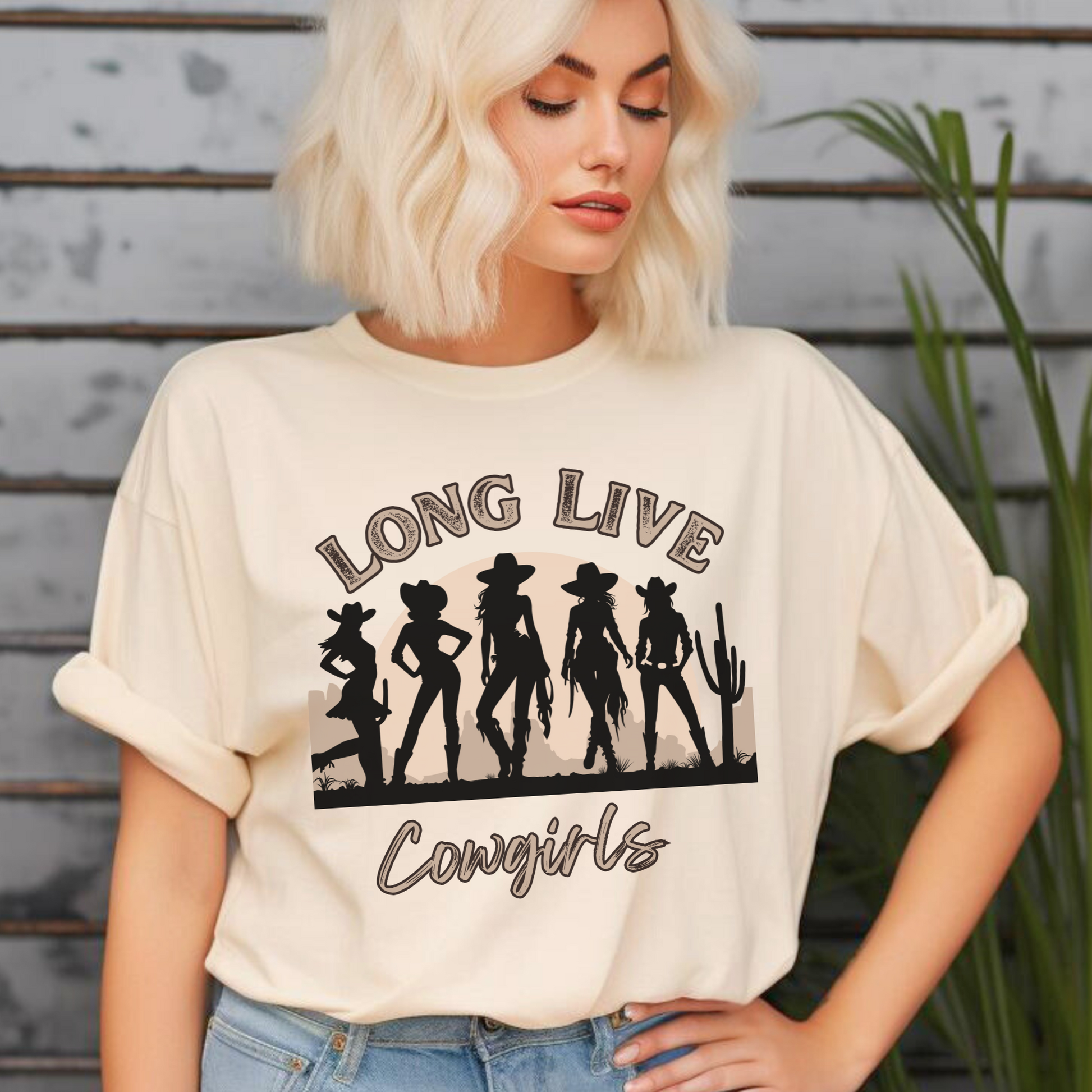 Image: A stylish oversized t-shirt for country girls who live for rodeos, festivals, and the wild west. The Long Live Cowgirls slogan stands bold over a desert scene with five iconic cowgirl silhouettes, bringing vintage western charm to any wardrobe. Whether you are hitting a country concert or just love rustic style, this soft and breathable tee is a fashionable and fun choice, by jaecrece.