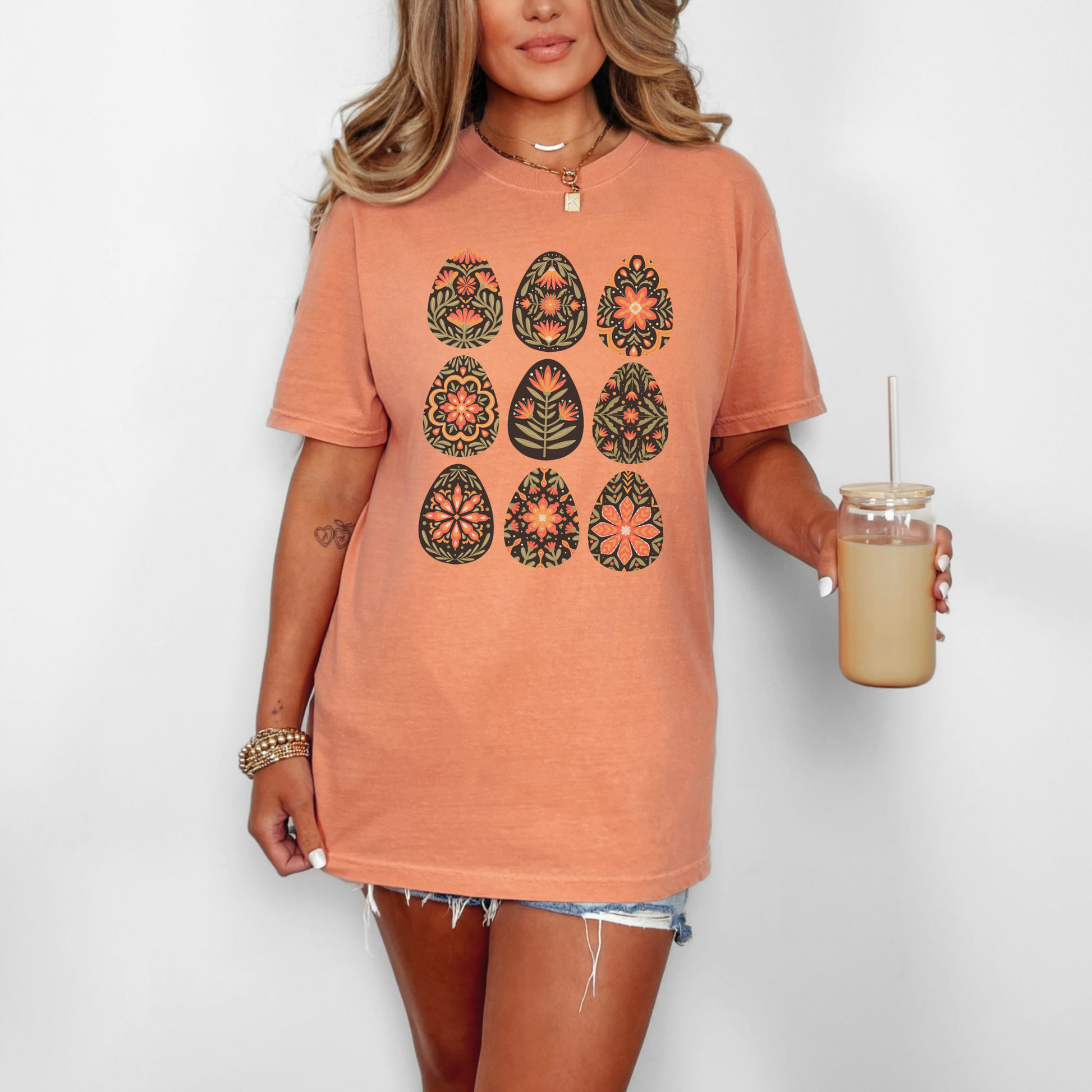 Image: This folk art Easter shirt features a vibrant floral and botanical Easter egg design with vintage Scandinavian influences. The intricate patterns reflect traditional Nordic craftsmanship, creating a timeless spring fashion statement. Perfect for casual outings or Easter festivities, this soft and stylish t-shirt brings together the beauty of cottagecore, boho aesthetics, and Swedish hygge in one charming piece, by jaecrece.